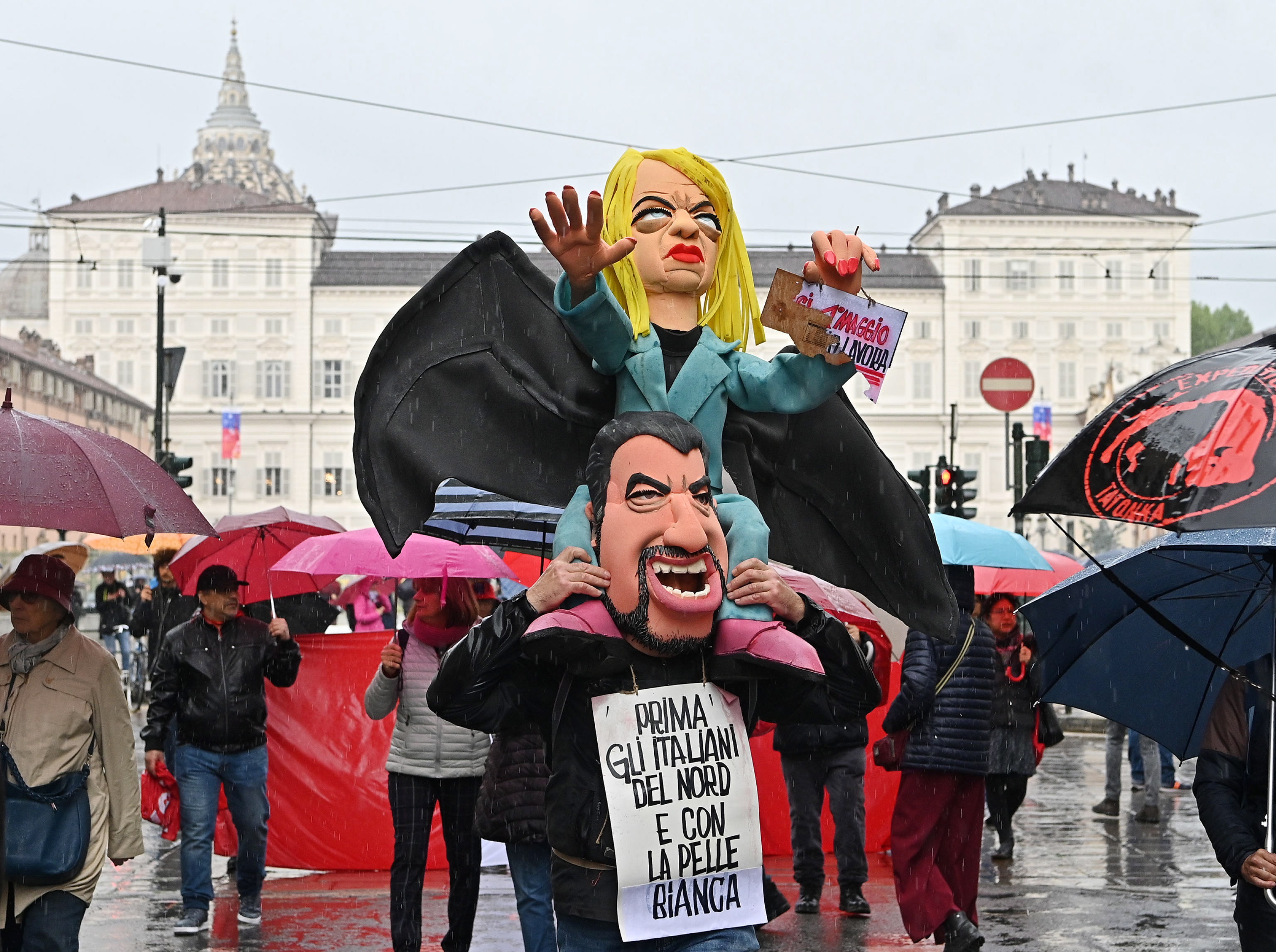 Turin (Italy), 01/05/2023.- Puppets depicting Italian Prime Minister Giorgia Meloni (top) gesturing the raised-arm salute over the shoulders of Deputy Prime Minister Matteo Salvini with a banner reading 'first the Italians from the north and with white skin' during a demonstration on the occasion of International Workers' Day, in Turin, northern Italy, 01 May 2023. Labor Day, or May Day, is observed all over the world on the first day of May to celebrate the economic and social achievements of workers and fight for laborers rights. (Italia) EFE/EPA/ALESSANDRO DI MARCO