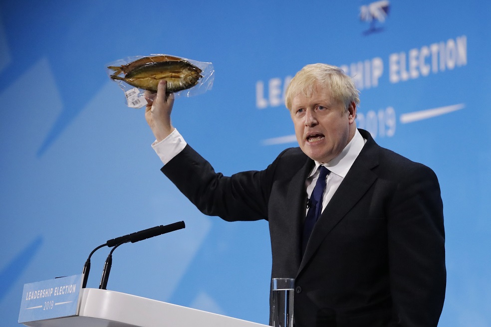 (FILES) In this file photo taken on July 17, 2019 Conservative MP and leadership contender Boris Johnson holds up kipper fish in plastic packaging as he speaks at the final Conservative Party leadership election hustings in London, on July 17, 2019.
Almost in the same breath, Boris Johnson supporters hail his optimistic vision for Britain, while reassuring the listener that he will have a team to take care of the details. The ex-London mayor has wooed Tories with a promise to get Britain out of the European Union and if elected party leader, he will take over as prime minister on July 24. But critics are alarmed at how Johnson seems to struggle with the finer points of Brexit, and question his attention to detail in previous jobs.
/ AFP / Tolga AKMEN / TO GO WITH AFP STORY BY ALICE RITCHIE