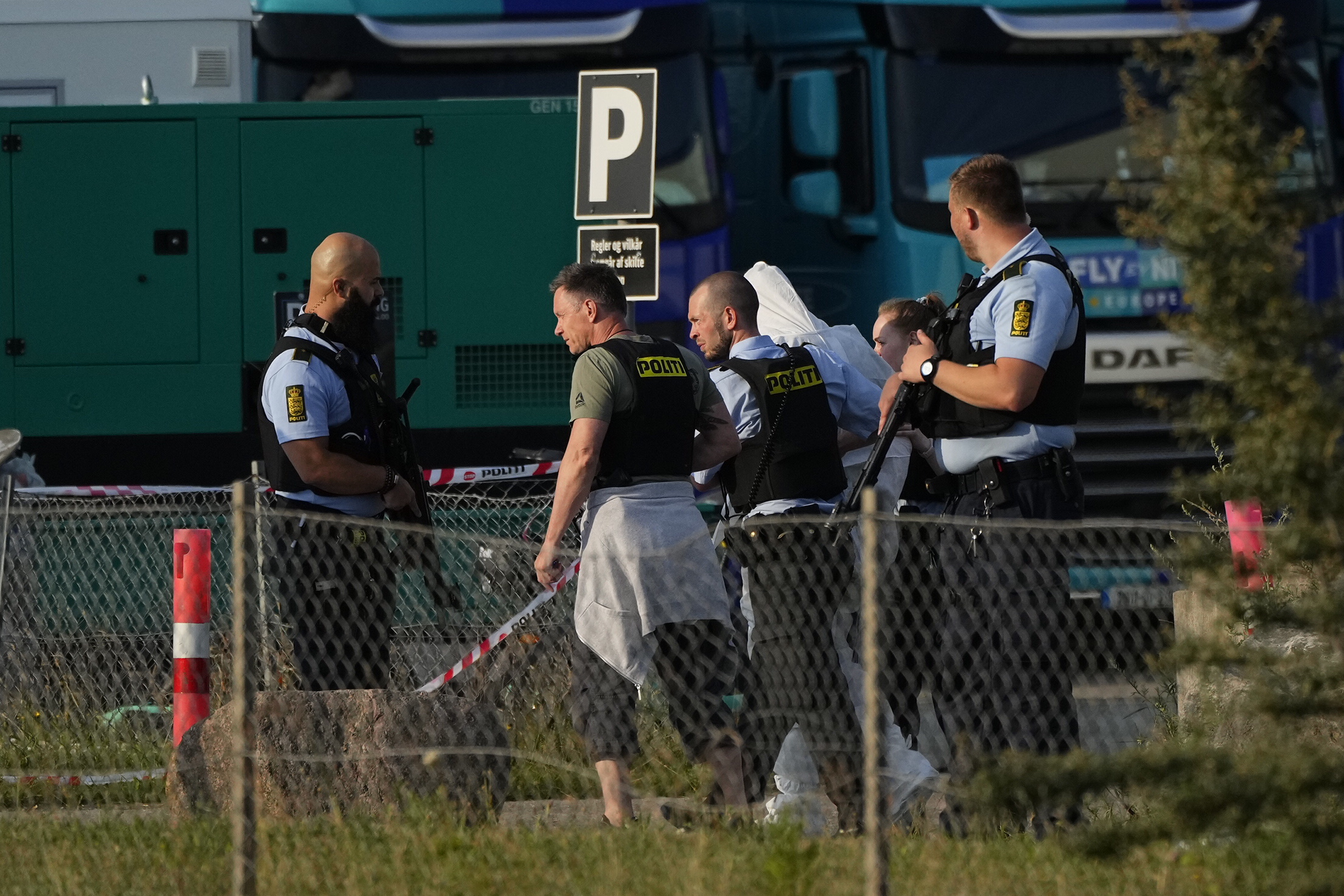 Oerestad (Denmark), 03/07/2022.- Armed police escort a person in front of the Field's shopping center during evacuation, in Oerstad, Copenhagen, Denmark, 03 July 2022. Several people have been shot in Fields shopping center in Copenhagen and one person has been arrested. (Dinamarca, Copenhague) EFE/EPA/Claus Bech DENMARK OUT