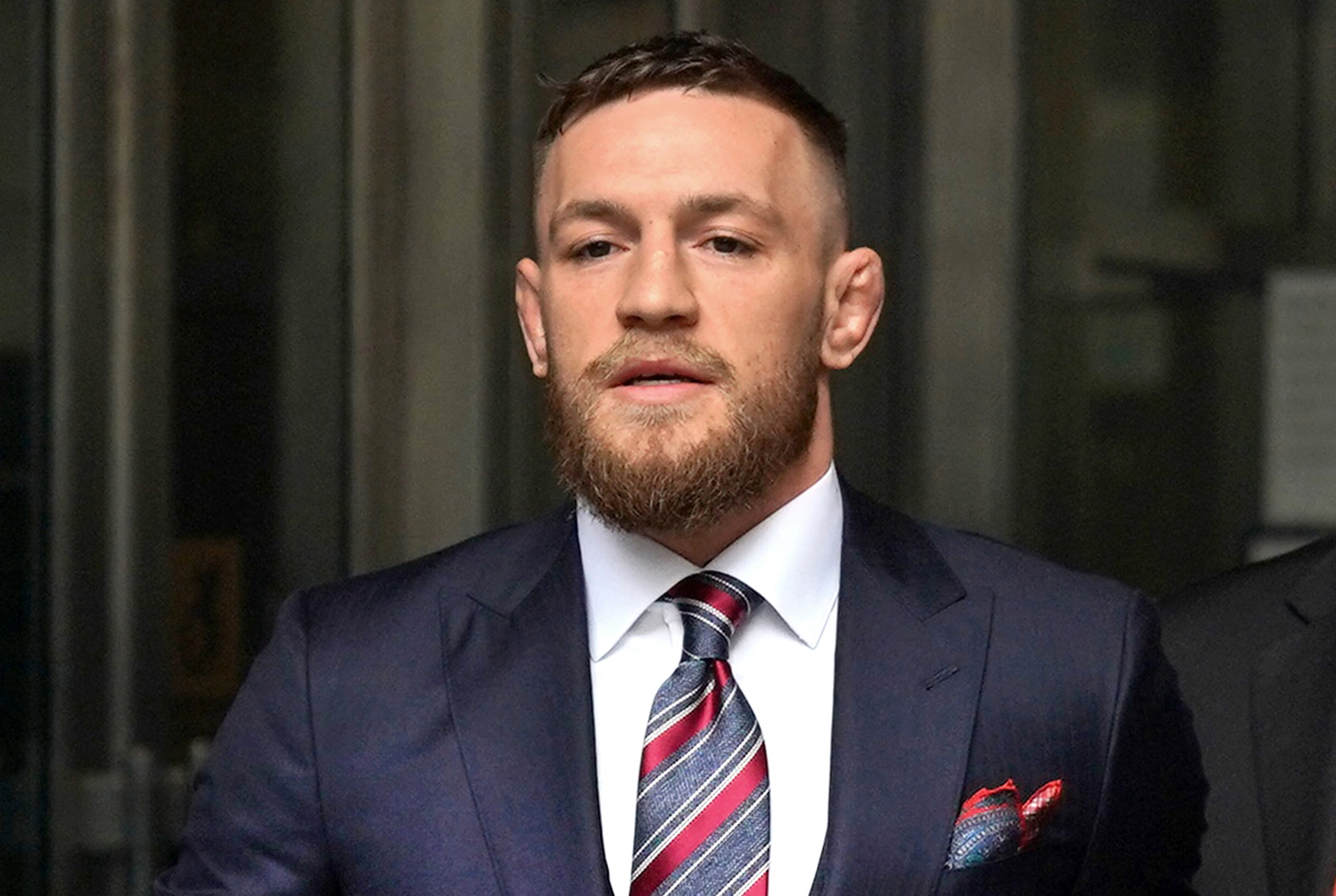 (FILES) Irish mixed martial arts fighter Conor McGregor (C) arrives to talk to the press after he pleaded guilty to a single violation of disorderly conduct in Brooklyn Criminal Court, on July 26, 2018.