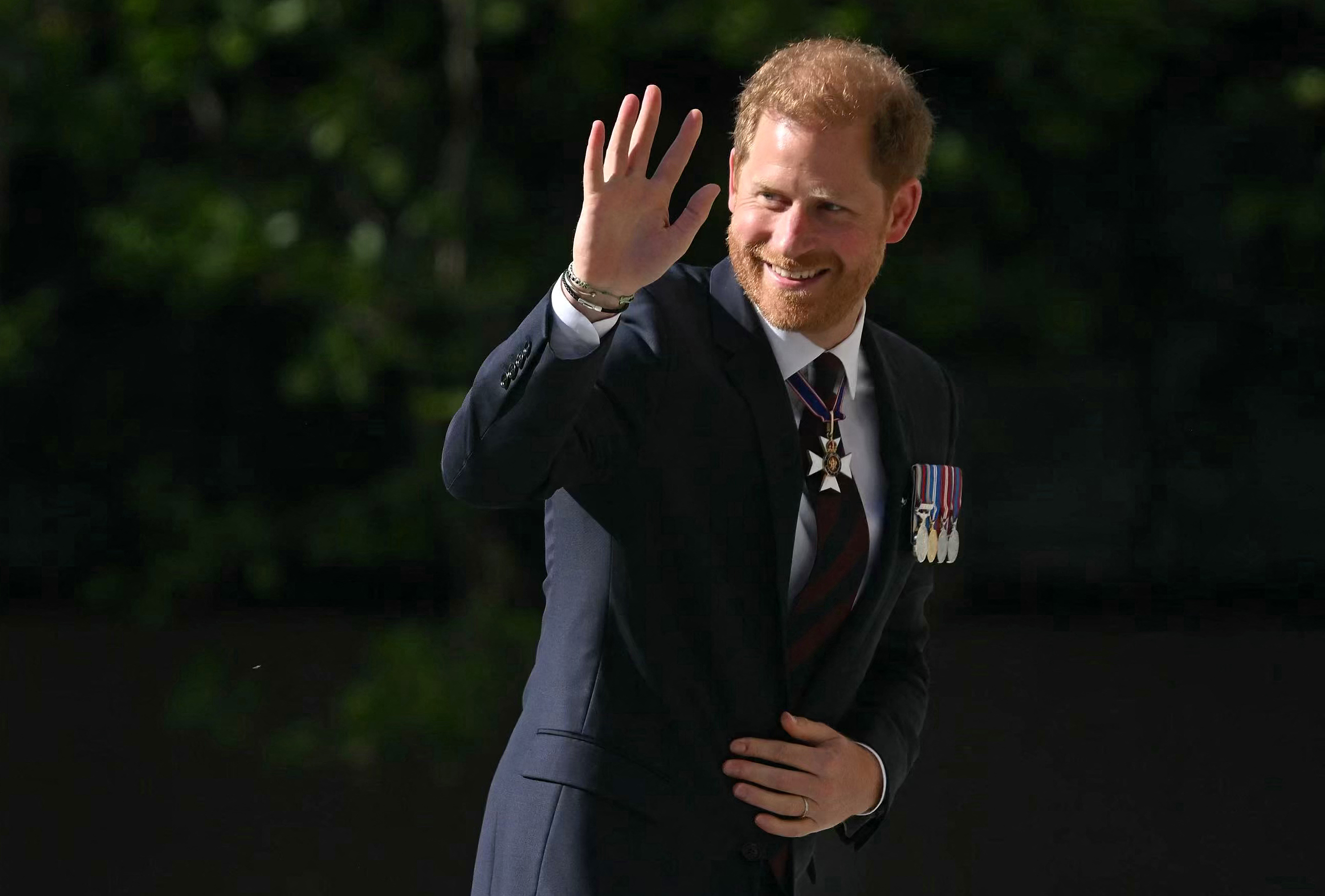 (FILES) Britain's Prince Harry, Duke of Sussex waves as he arrives to attend a ceremony marking the 10th anniversary of the Invictus Games, at St Paul's Cathedral in central London, on May 8, 2024. - Prince Harry was once one of the British royal family's most popular members but as he celebrates his 40th birthday this weekend he is increasingly distanced from the UK public and his own family (Photo by JUSTIN TALLIS / AFP)