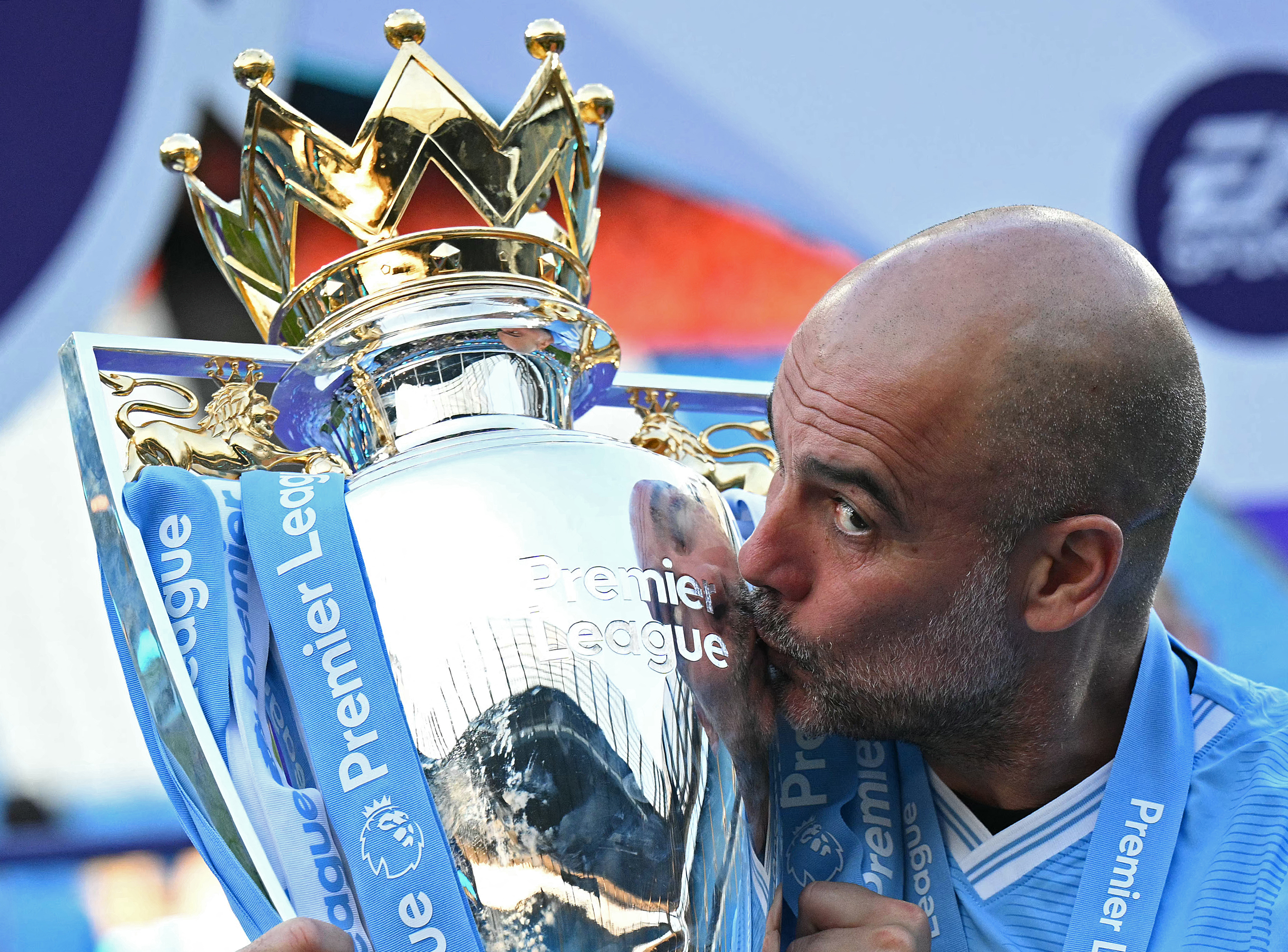 (FILES) Manchester City's Spanish manager Pep Guardiola kisses the Premier League trophy after the presentation ceremony following the English Premier League football match between Manchester City and West Ham United at the Etihad Stadium in Manchester, north west England, on May 19, 2024.