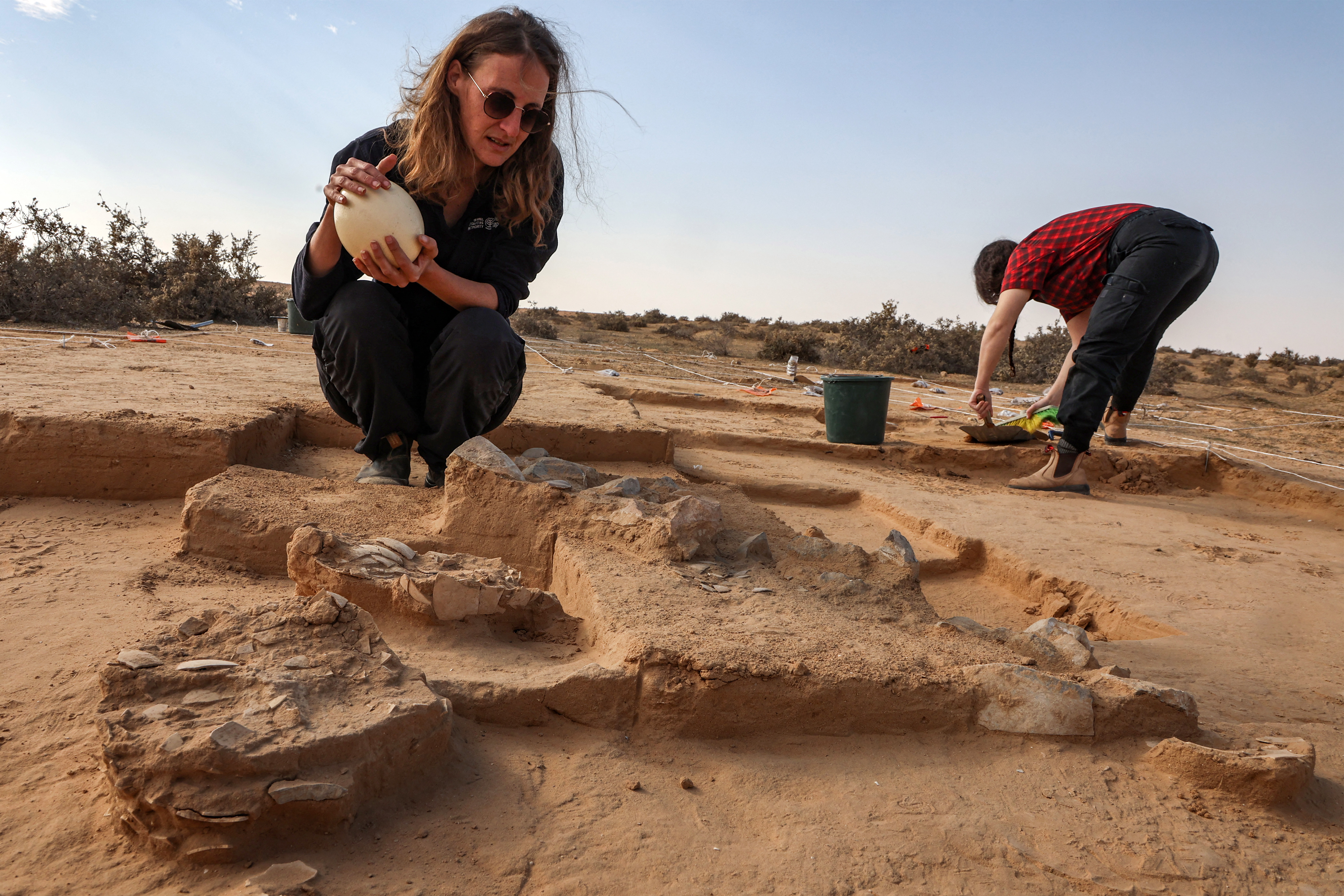 This picture taken on January 12, 2023 shows a view of discovered ostrich egg fragments dating over 4000 years discovered by the Israel Antiquities Authority (IAA) at a site in the dunes near Nitzana along the Israel-Egypt border in the western Negev desert. - Experts say the finds provide insight into the life of the ancient peoples inhabiting the region. The eight crushed eggs were located at a camp site used by nomads "since prehistoric times," said Lauren Davis, the Israel Antiquities Authority excavation director. Their proximity to the fire, alongside stones, flint, tools and pottery sherds, implies that the eggs were to be cooked, said Davis. (Photo by GIL COHEN-MAGEN / AFP)