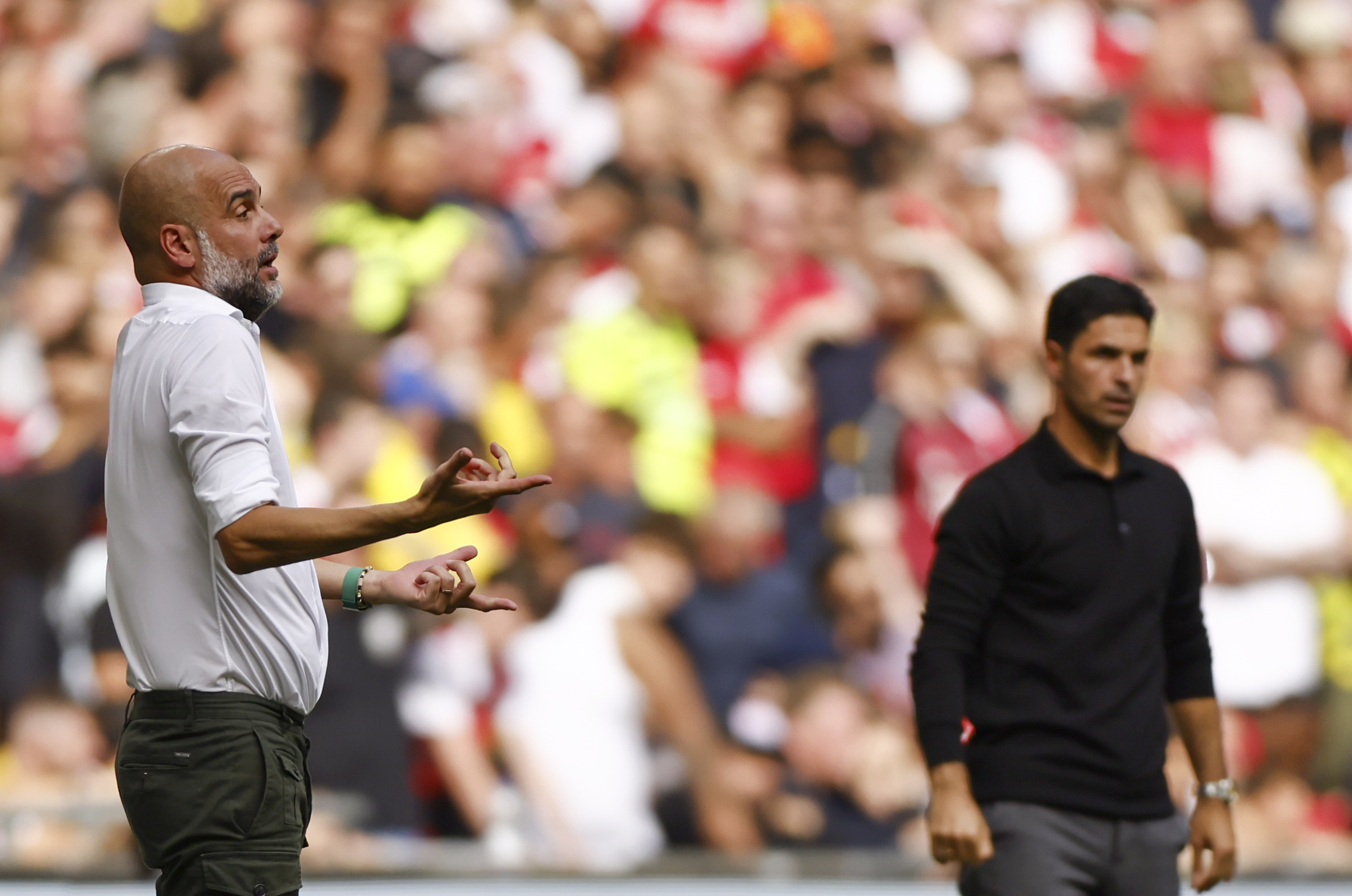 London (United Kingdom), 06/08/2023.- Manchester City manager Pep Guardiola (L) and Arsenal manager Mikel Arteta (R) react during the FA Community Shield soccer match between Arsenal London and Manchester City in London, Britain, 06 August 2023. (Reino Unido, Londres) EFE/EPA/TOLGA AKMEN