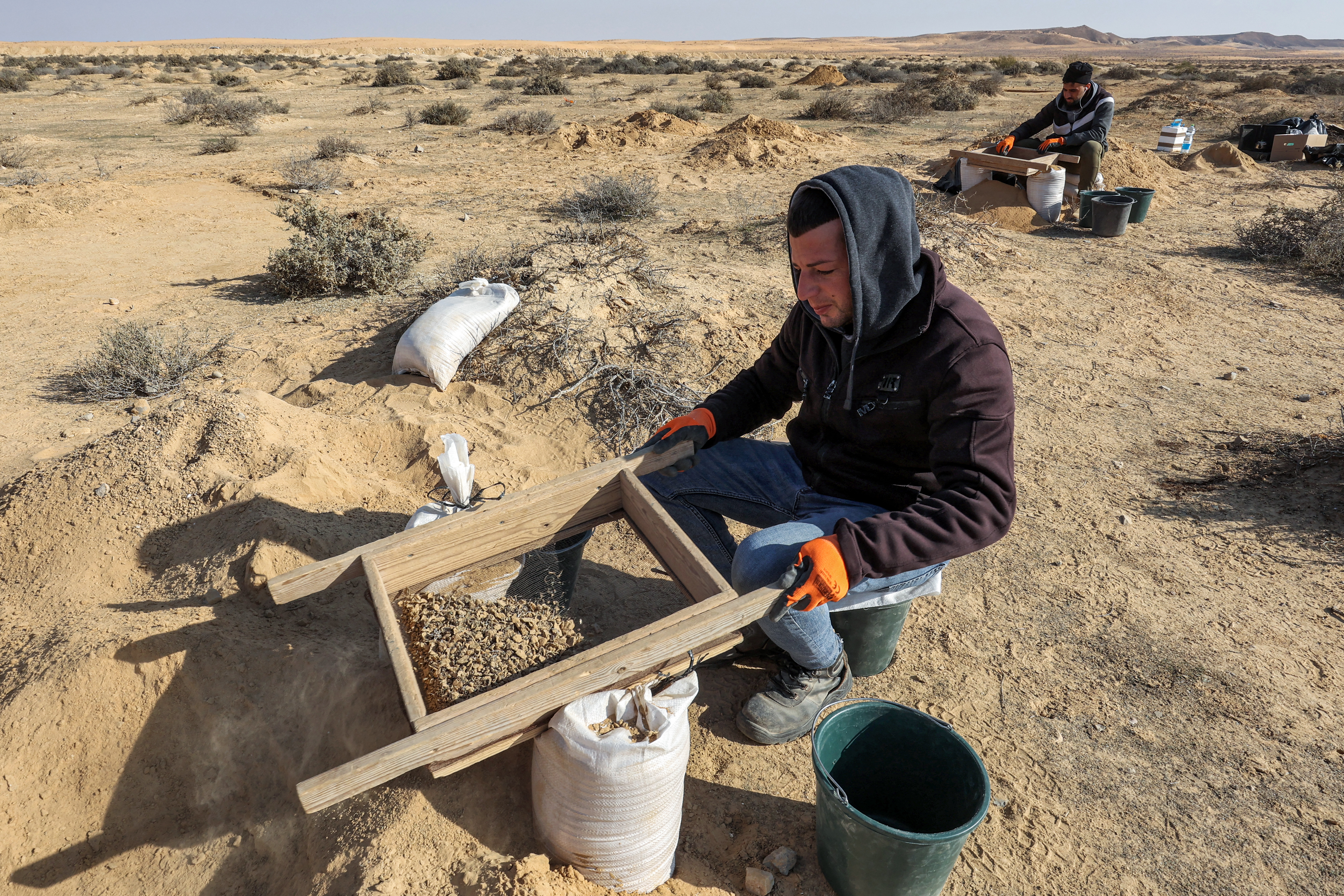 This picture taken on January 12, 2023 shows a view of discovered ostrich egg fragments dating over 4000 years discovered by the Israel Antiquities Authority (IAA) at a site in the dunes near Nitzana along the Israel-Egypt border in the western Negev desert. - Experts say the finds provide insight into the life of the ancient peoples inhabiting the region. The eight crushed eggs were located at a camp site used by nomads "since prehistoric times," said Lauren Davis, the Israel Antiquities Authority excavation director. Their proximity to the fire, alongside stones, flint, tools and pottery sherds, implies that the eggs were to be cooked, said Davis. (Photo by GIL COHEN-MAGEN / AFP)
