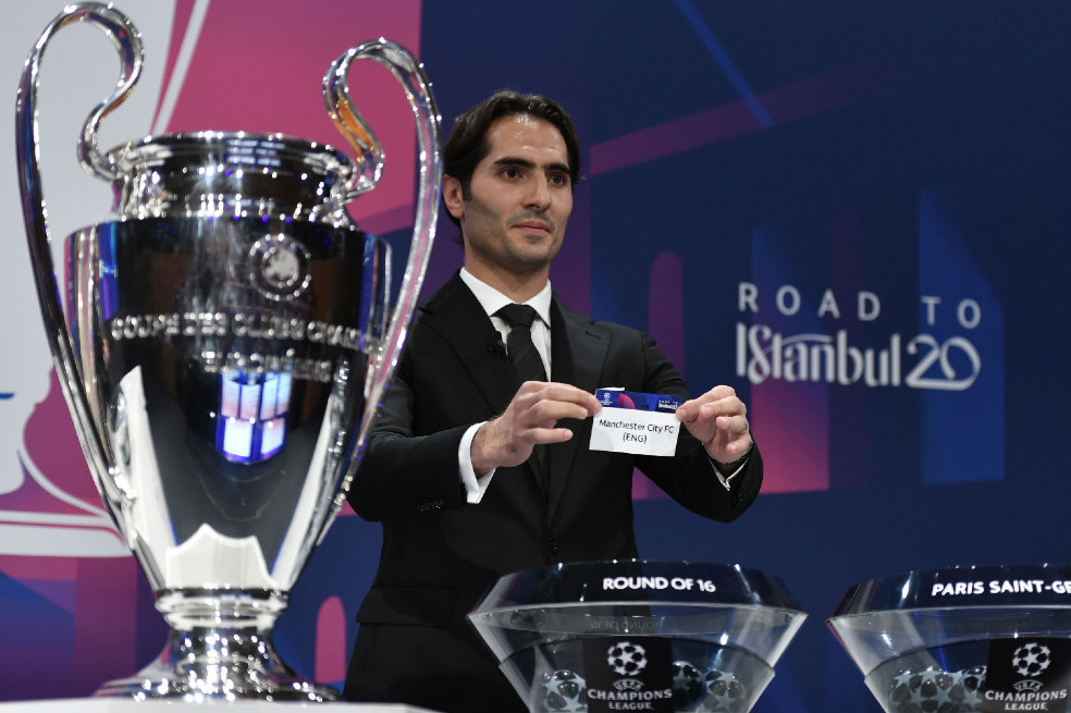 (FILES) In this file photo taken on December 16, 2019 UEFA Champions League's ambassador Hamit Altintop holds the slip of Manchester City during the UEFA Champions League football cup round of 16 draw ceremony on December 16, 2019 in Nyon. Manchester City will be free to play Champions League football next season after the Court of Arbitration for Sport lifted a two-season ban from European competitions imposed by UEFA on July 13, 2020. / AFP / Fabrice COFFRINI