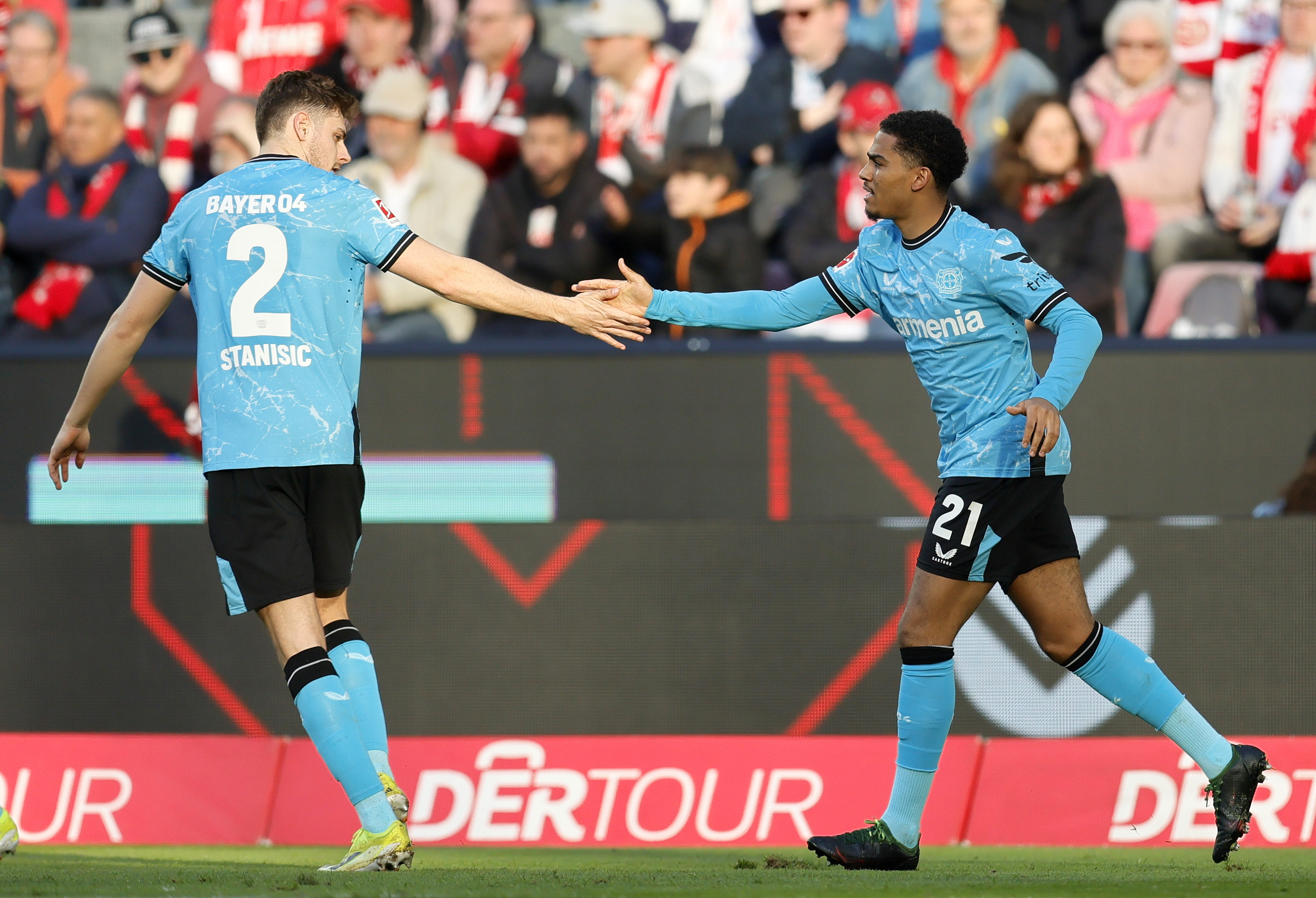 Cologne (Germany), 03/03/2024.- Leverkusen's Amine Adli (R) celebrates with teammate Josip Stanisic after his assist for the 2-0 lead during the German Bundesliga soccer match between 1. FC Cologne and Bayer 04 Leverkusen in Cologne, Germany, 03 March 2024. (Alemania, Colonia) EFE/EPA/RONALD WITTEK CONDITIONS - ATTENTION: The DFL regulations prohibit any use of photographs as image sequences and/or quasi-video.