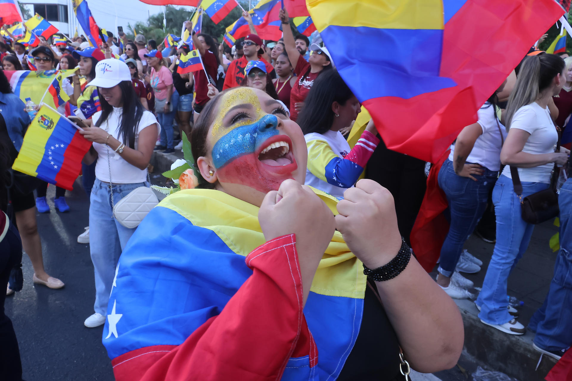 AME1972. CIUDAD DE PANAMÁ (PANAMÁ), 03/01/2026.- Una ciudadana venezolana celebra durante una manifestación tras la captura del presidente de Venezuela, Nicolás Maduro, en el parque Urracá este sábado, en Ciudad de Panamá (Panamá). Decenas de venezolanos se dieron "un abrazo de alegría" en Panamá por la captura de Maduro por parte de las fuerzas especiales de Estados Unidos, una acción militar que relacionan con la "libertad" de Venezuela, según afirmó un manifestante. EFE/ Gabriel Rodríguez