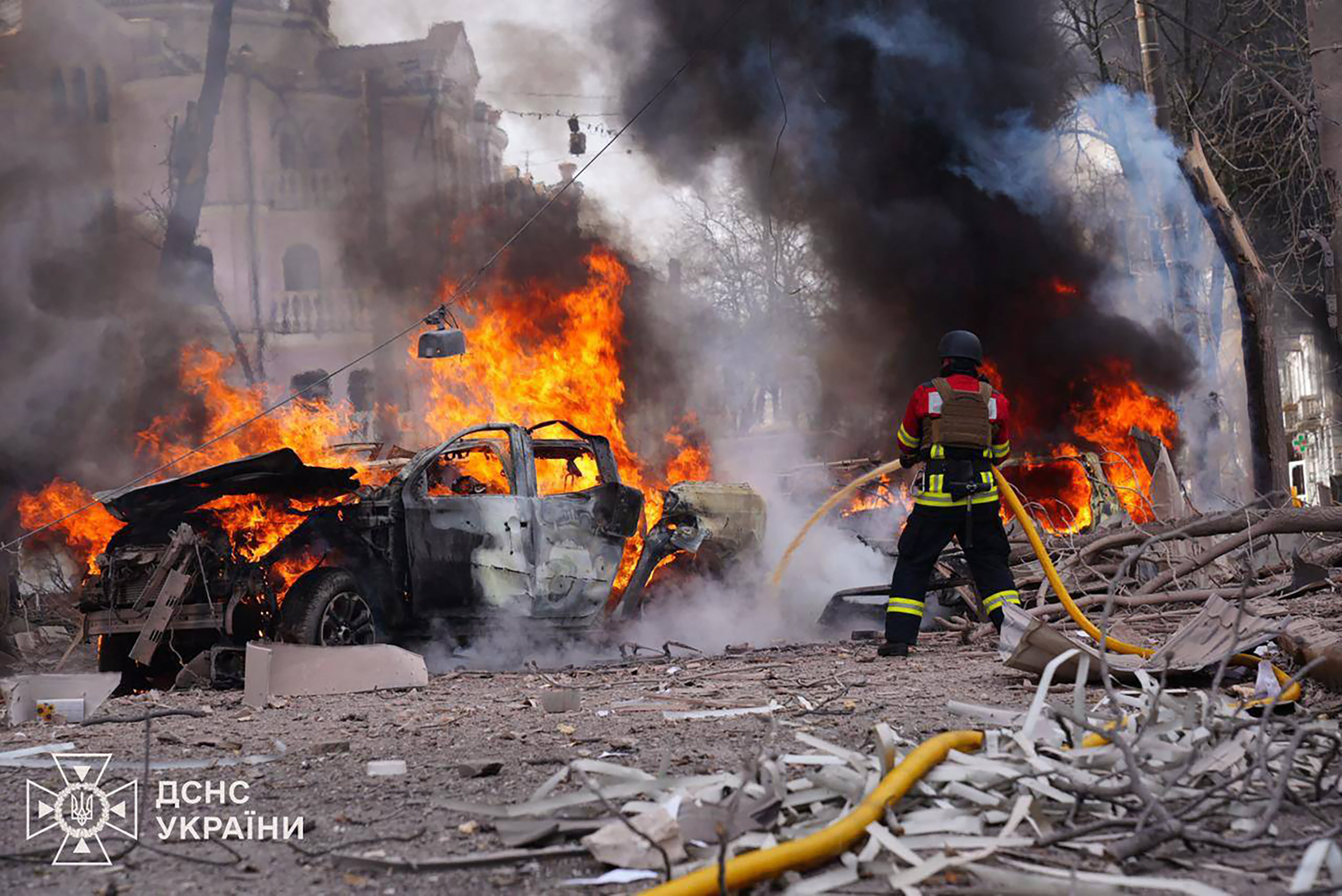 TOPSHOT - In this handout photograph taken and released by the Ukrainian Emergency Service on April 13, 2025, a Ukrainian rescuer works to extinguish a fire at the site of a missile attack in Sumy, northeastern Ukraine, amid the Russian invasion of Ukraine.