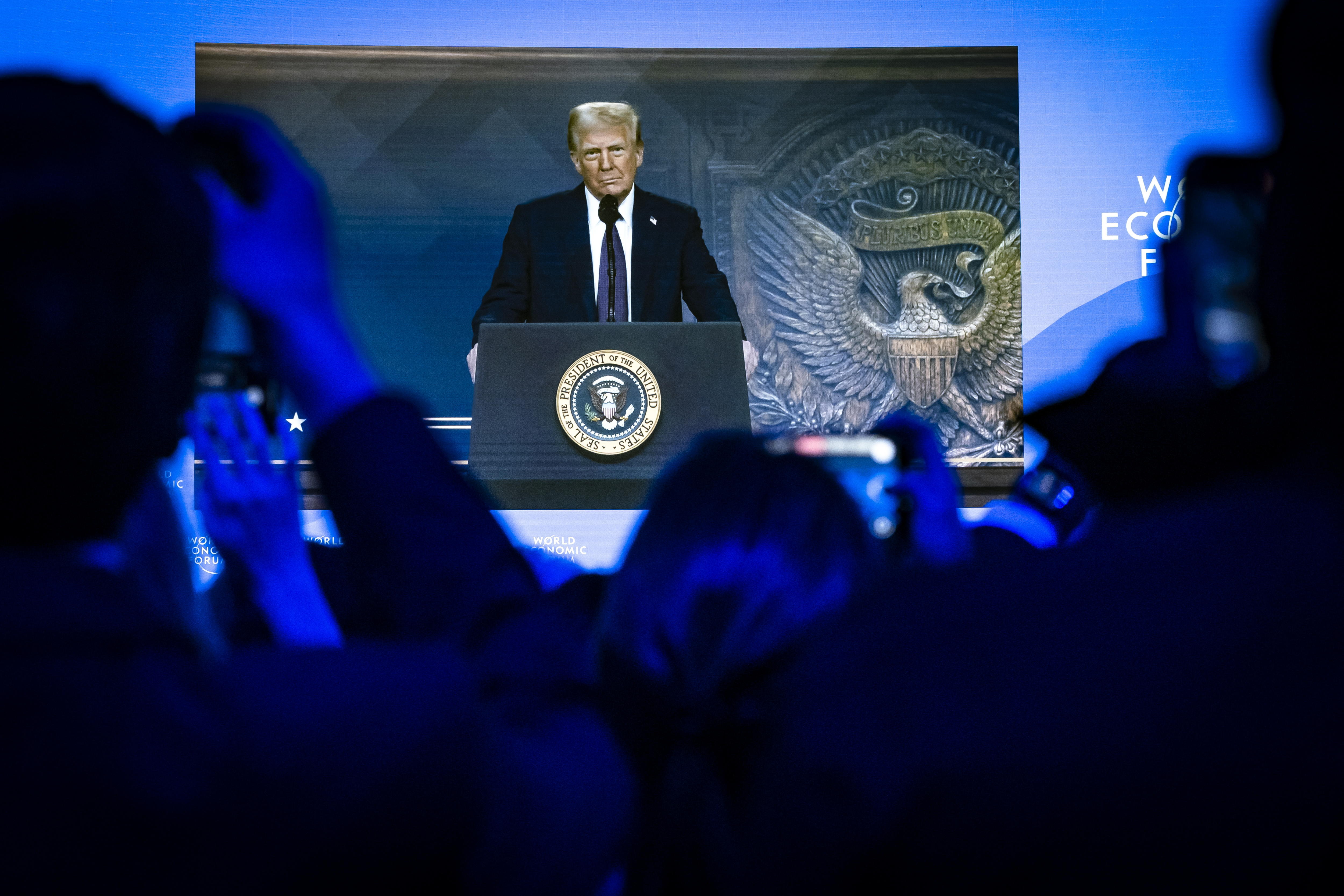 Davos (Switzerland Schweiz Suisse), 23/01/2025.- US President Donald J. Trump is shown on a screen as he addresses via remote connection a plenary session in the Congress Hall during the 55th annual meeting of the World Economic Forum (WEF) in Davos, Switzerland, 23 January 2025. The World Economic Forum annual meeting brings together entrepreneurs, scientists, corporate and political leaders in Davos and takes place from January 20 to 24. (Suiza) EFE/EPA/MICHAEL BUHOLZER