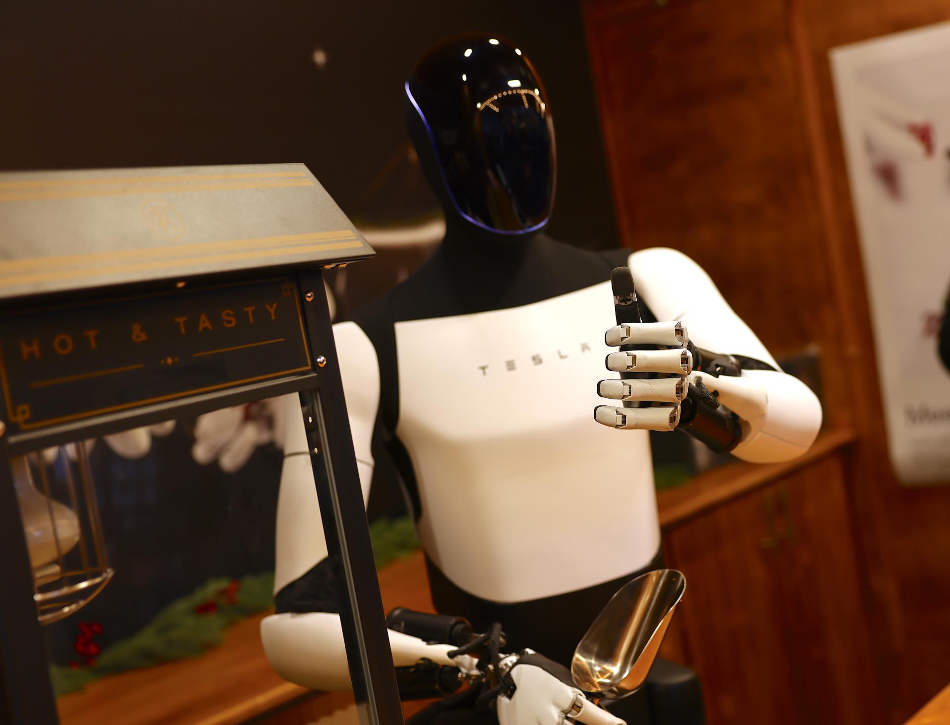 Berlin (Germany), 20/12/2025.- A Tesla Optimus robot serves popcorn during a promotional event in a shopping mall in Berlin, Germany, 20 December 2025. Tesla showcased its humanoid robot Optimus for the first time in Germany at the Mall of Berlin on 20 December, offering a live demo, task performances, and merchandise to attendees. (Alemania) EFE/EPA/HANNIBAL HANSCHKE
