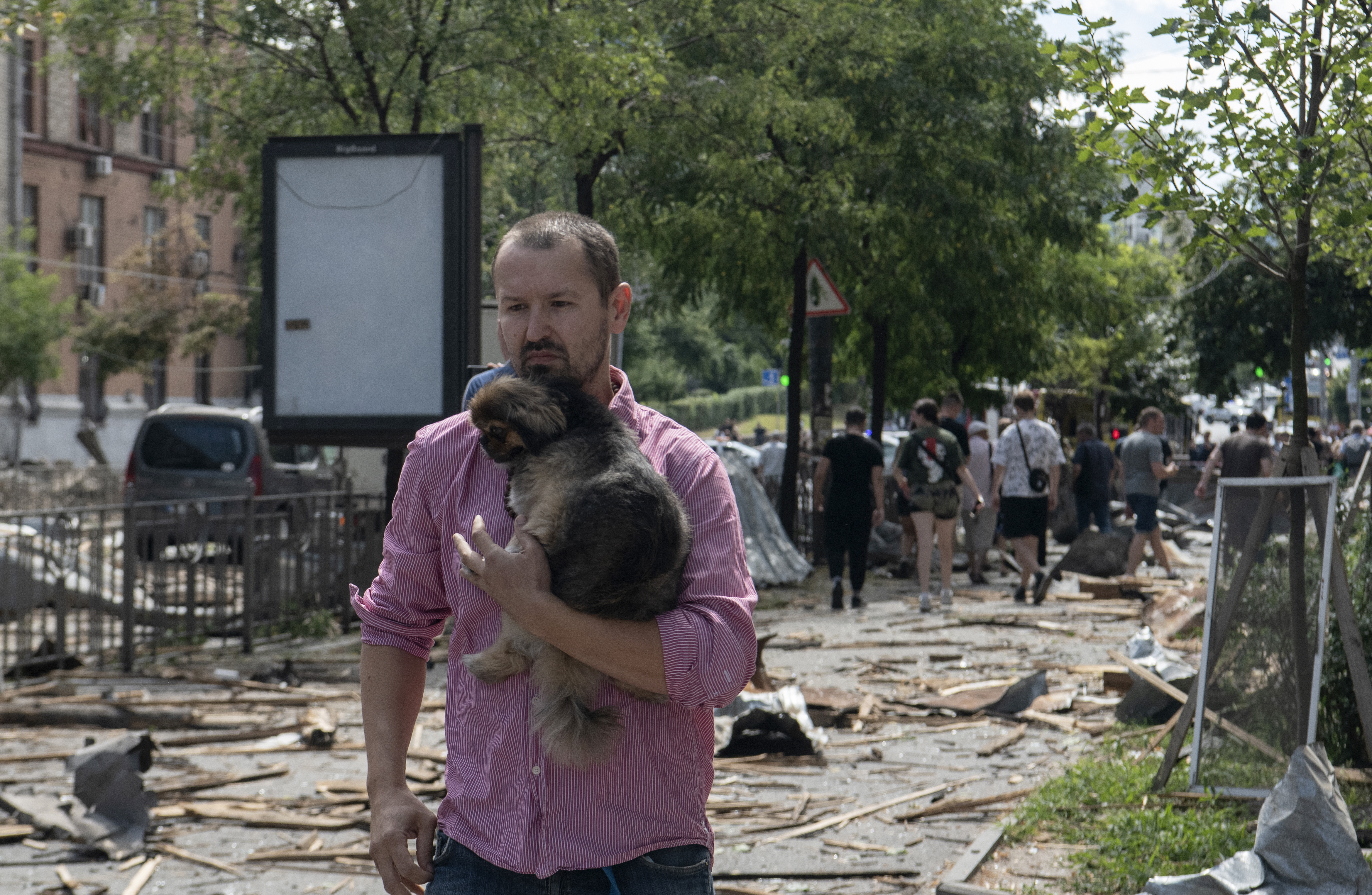 Kyiv (Ukraine), 08/07/2024.- A local man holding a dog walks in a street covered with debris after a missile strike in Kyiv, Ukraine, 08 July 2024, amid the Russian invasion. Russia massively attacked Ukraine with missiles on 08 July, striking the cities of Kyiv, Dnipro, Kryvyi Rih, Sloviansk and Kramatorsk. More than 40 missiles of different types were launched, striking residential buildings, infrastructure, and a children's hospital. At least 31 people have been killed and 125 others injured across Ukraine, according to Ukraine's State Emergency Service (SESU). In Kyiv, where at least 20 people were killed and 61 others were injured, the 'Ohmatdyt' children's hospital was hit, killing two people and injuring 10 others, SESU added. (Rusia, Ucrania, Kiev) EFE/EPA/VLADYSLAV MUSIIENKO