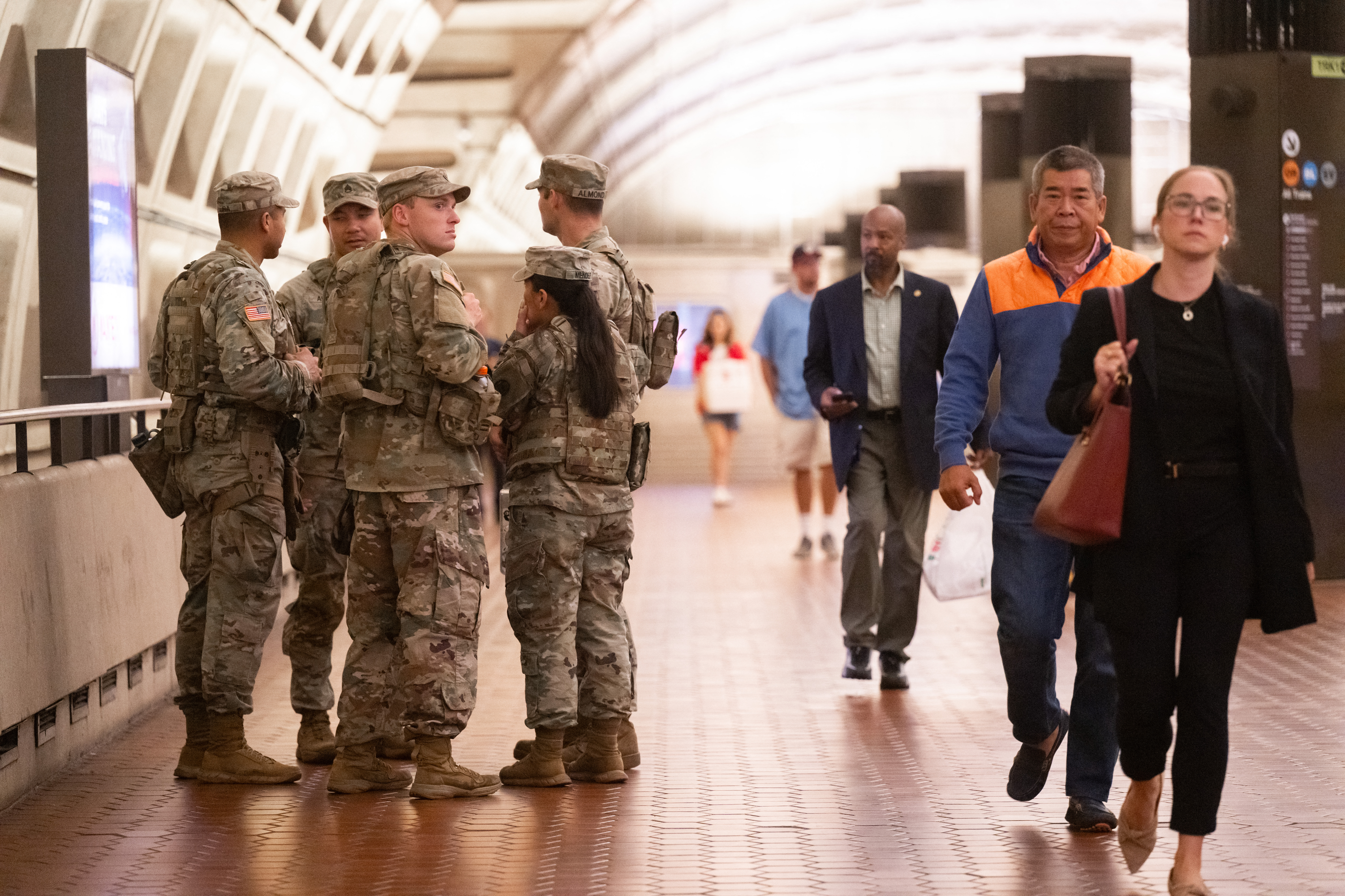 Members of the National Guard patrol inside the Metro Center Metrorail Station in Washington, DC, August 21, 2025. President Donald Trump said he plans to patrol Washington's streets on Thursday with troops he deployed to the US capital in a show of force against what he claims is a "crime emergency." Trump ordered hundreds of National Guard to deploy in Washington last week vowing to "take our capital back," despite protests by some residents and statistics showing violent offenses falling. (Photo by SAUL LOEB / AFP)