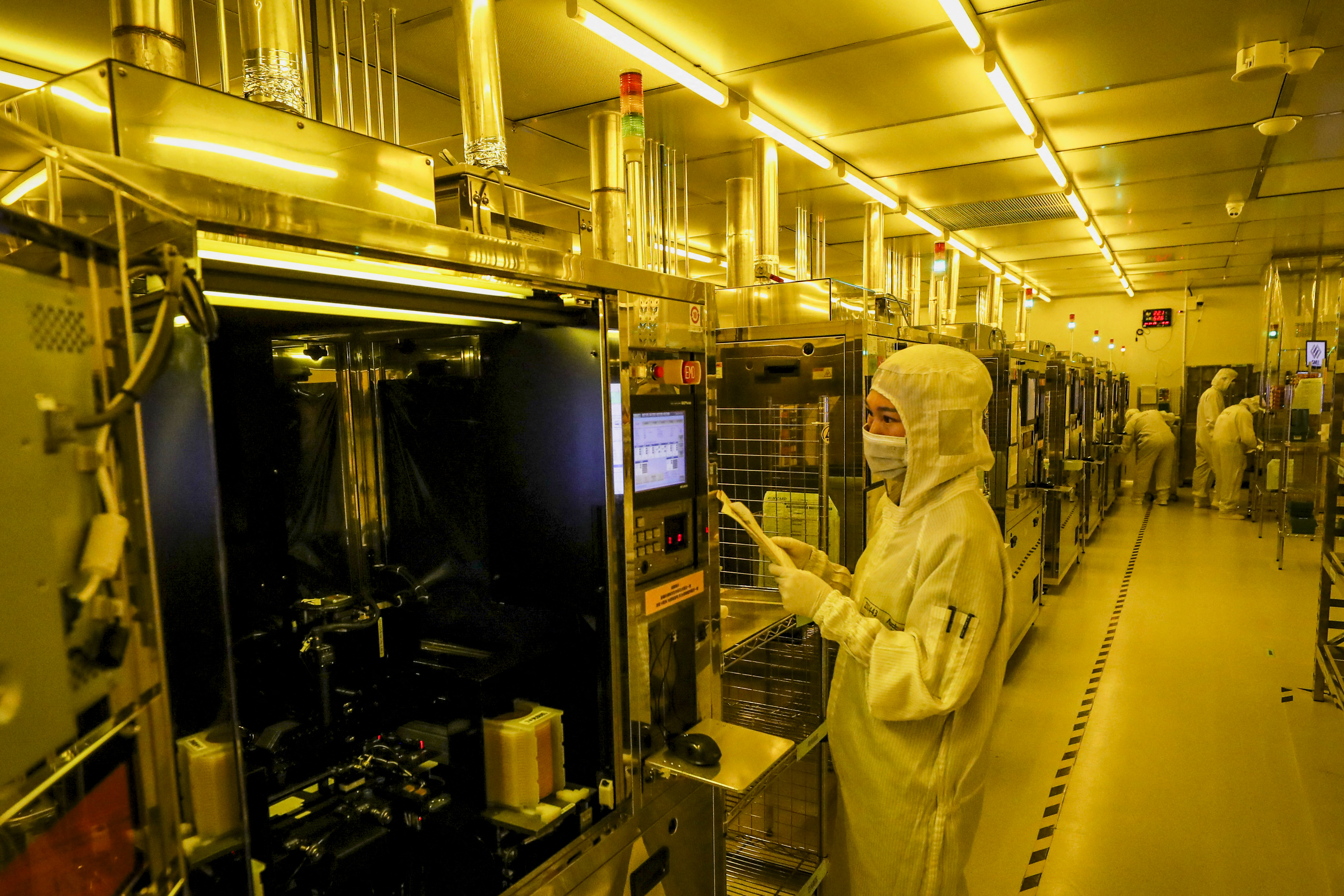 This photo taken on April 29, 2024 shows employees working at a semiconductor chips factory in Huai'an, in eastern China's Jiangsu province. (Photo by AFP) / CHINA OUT