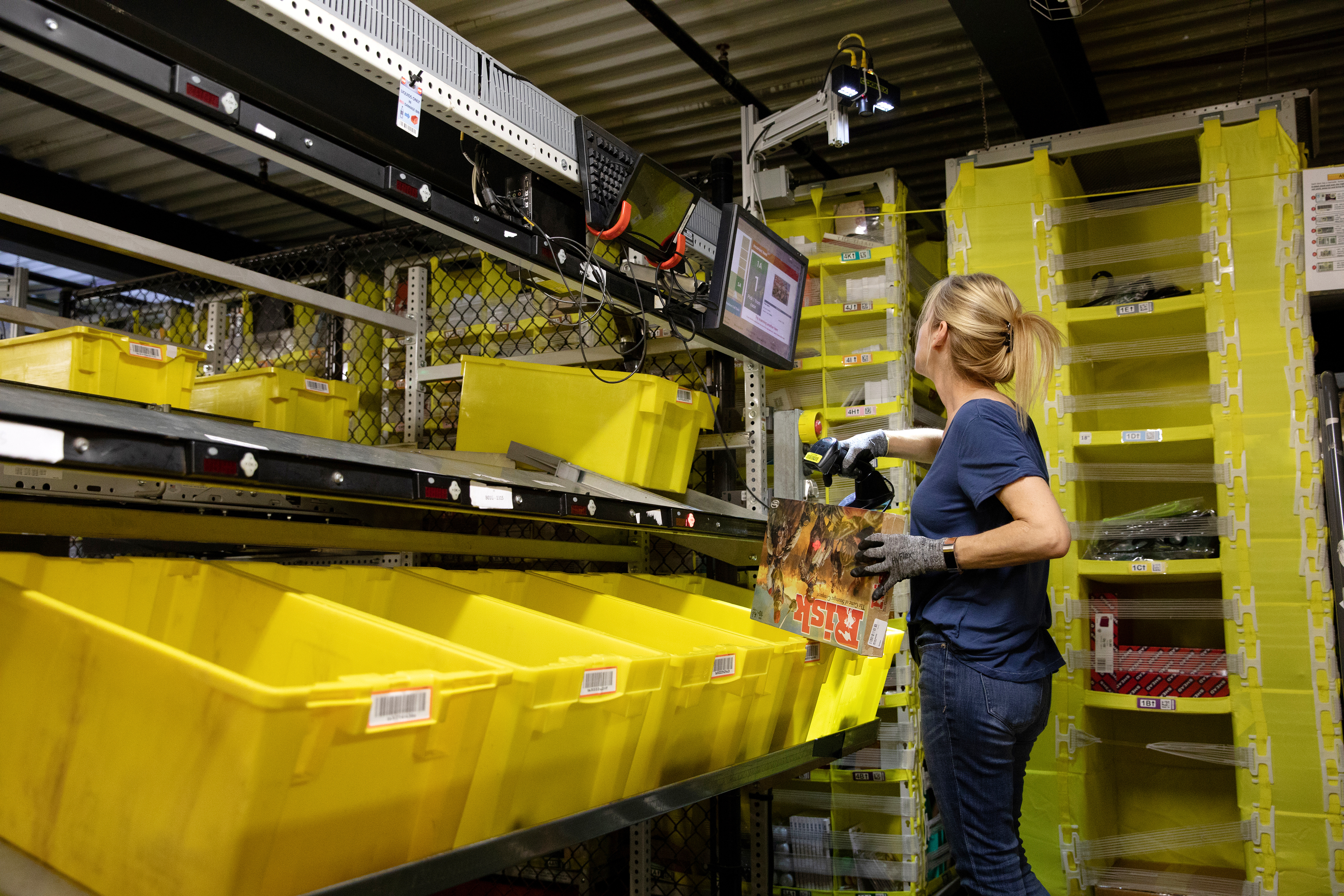 An employee scans an item at a fulfillment center in Robbinsville, New Jersey. Photographer: Bess Adler/Bloomberg
