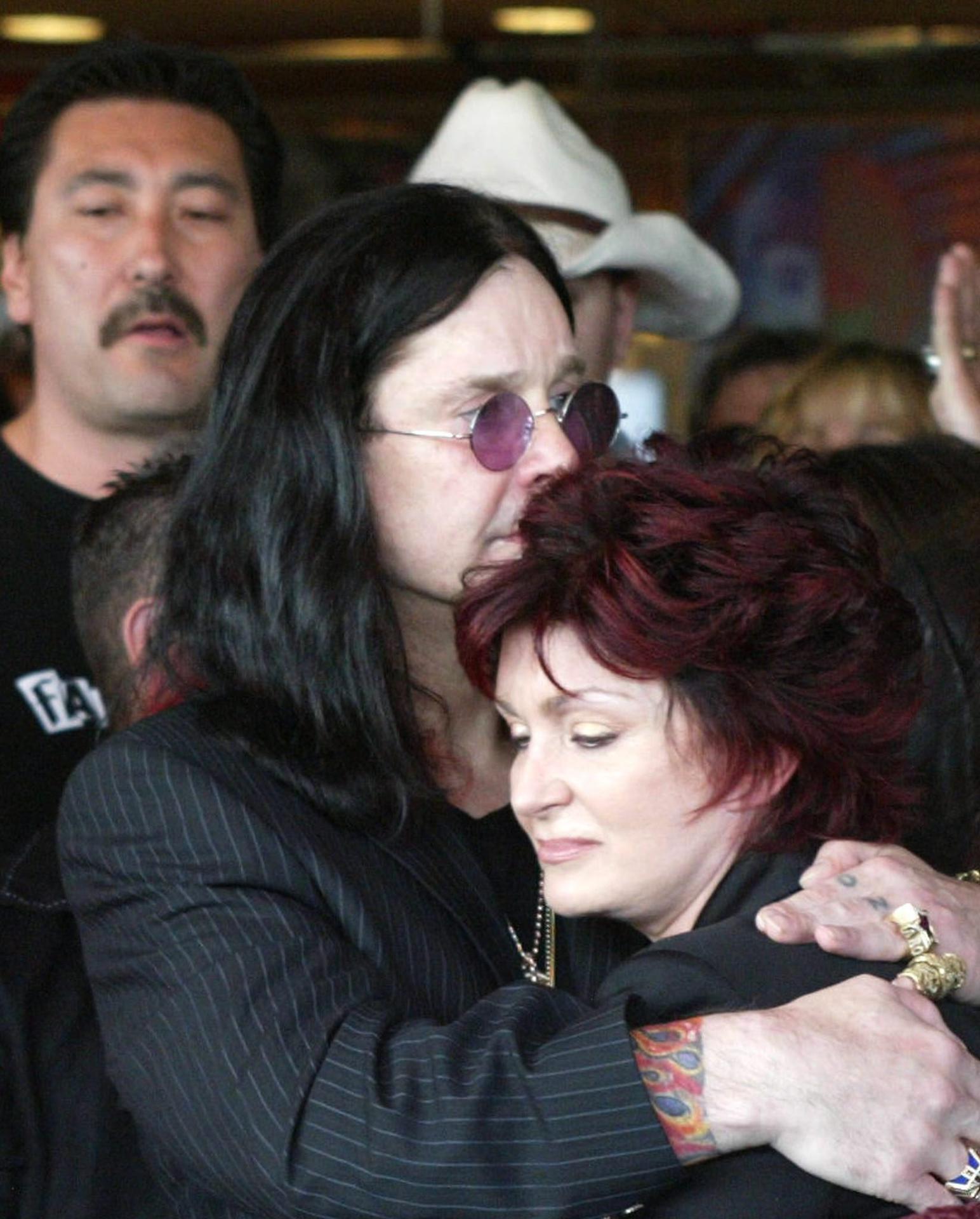 LOS ANGELES (United States), 22/07/2025.- (FILE) - Rock musician Ozzy Osbourne embraces his wife Sharon during ceremonies honoring late guitarist Randy Rhoads, guitarist for the Ozzy Osbourne band, who was inducted into the Hollywood RockWalk posthumously in Hollywood, Thursday 18 March 2004 (reissued 22 July 2025). Osbourne passed away aged 76 on 22 July 2025, weeks after performing his final concert with Black Sabbath, his family announced. He had been diagnosed with Parkinson's disease in 2019. (Reino Unido) EFE/EPA/ARMANDO ARORIZO
