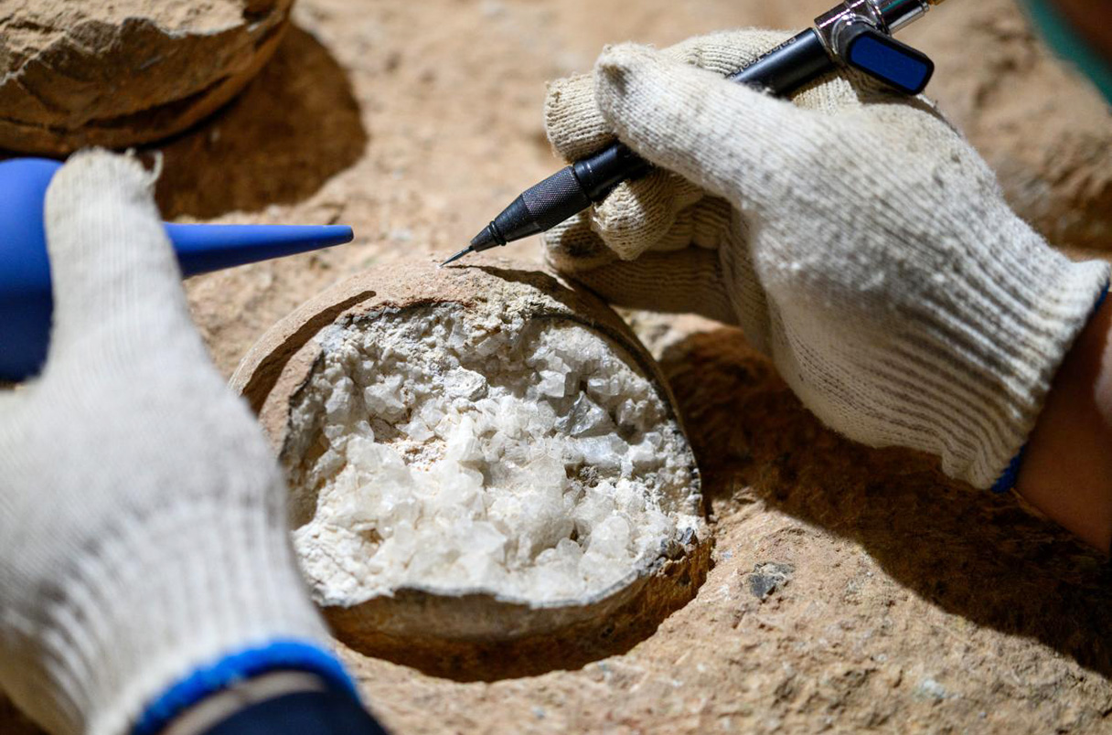 Científicos trabajan en huevos de dinosaurio llenos de calcita de la reserva fósil Qinglongshan de China. /Bi Zhao