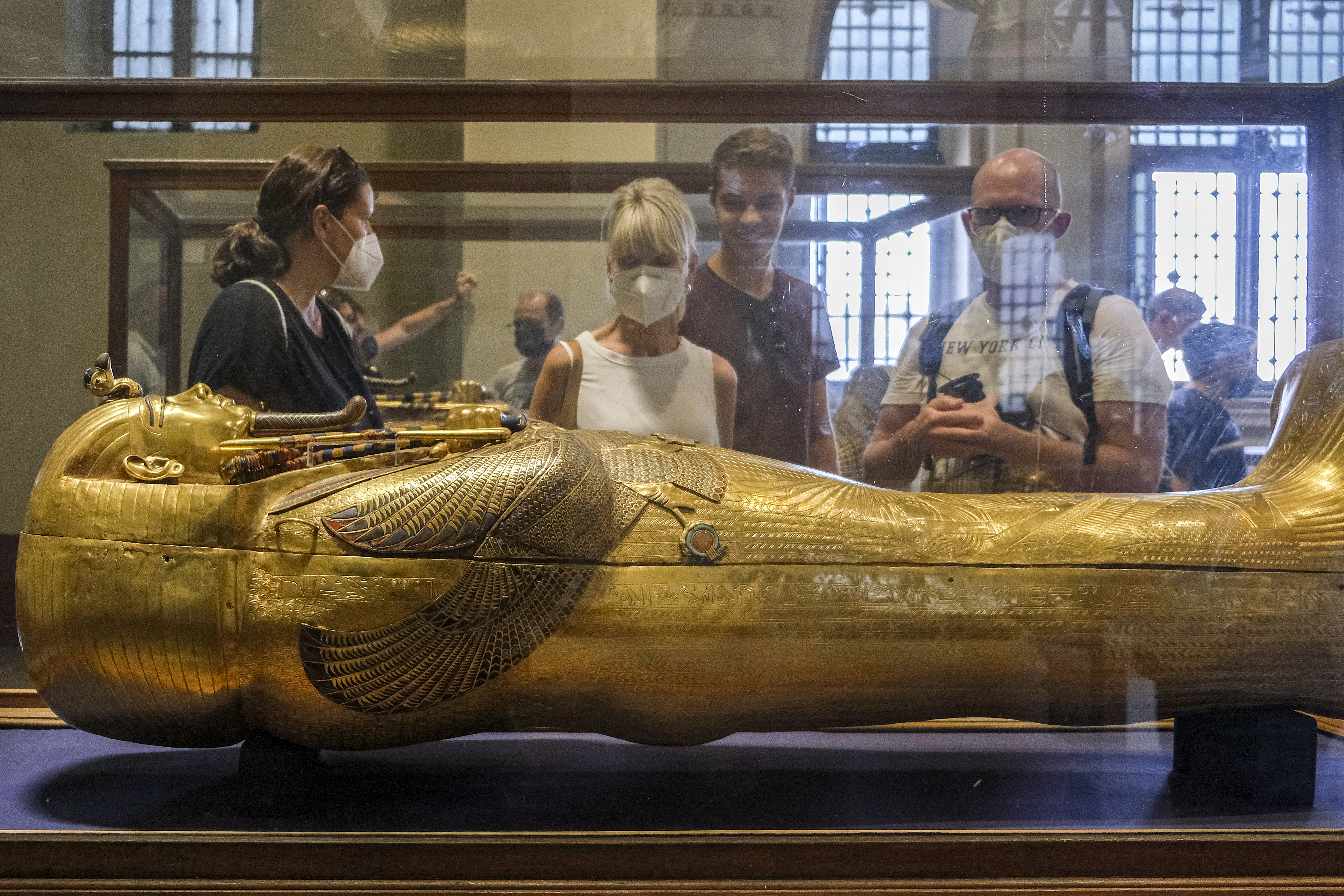 (FILES) Tourists view the solid gold sarcophagus of the Ancient Egyptian New Kingdom Pharaoh Tutankhamun (1342-1325 BC), at the pharaoh's dedicated gallery in the Egyptian Museum in the centre of Egypt's capital Cairo on October 27, 2021.