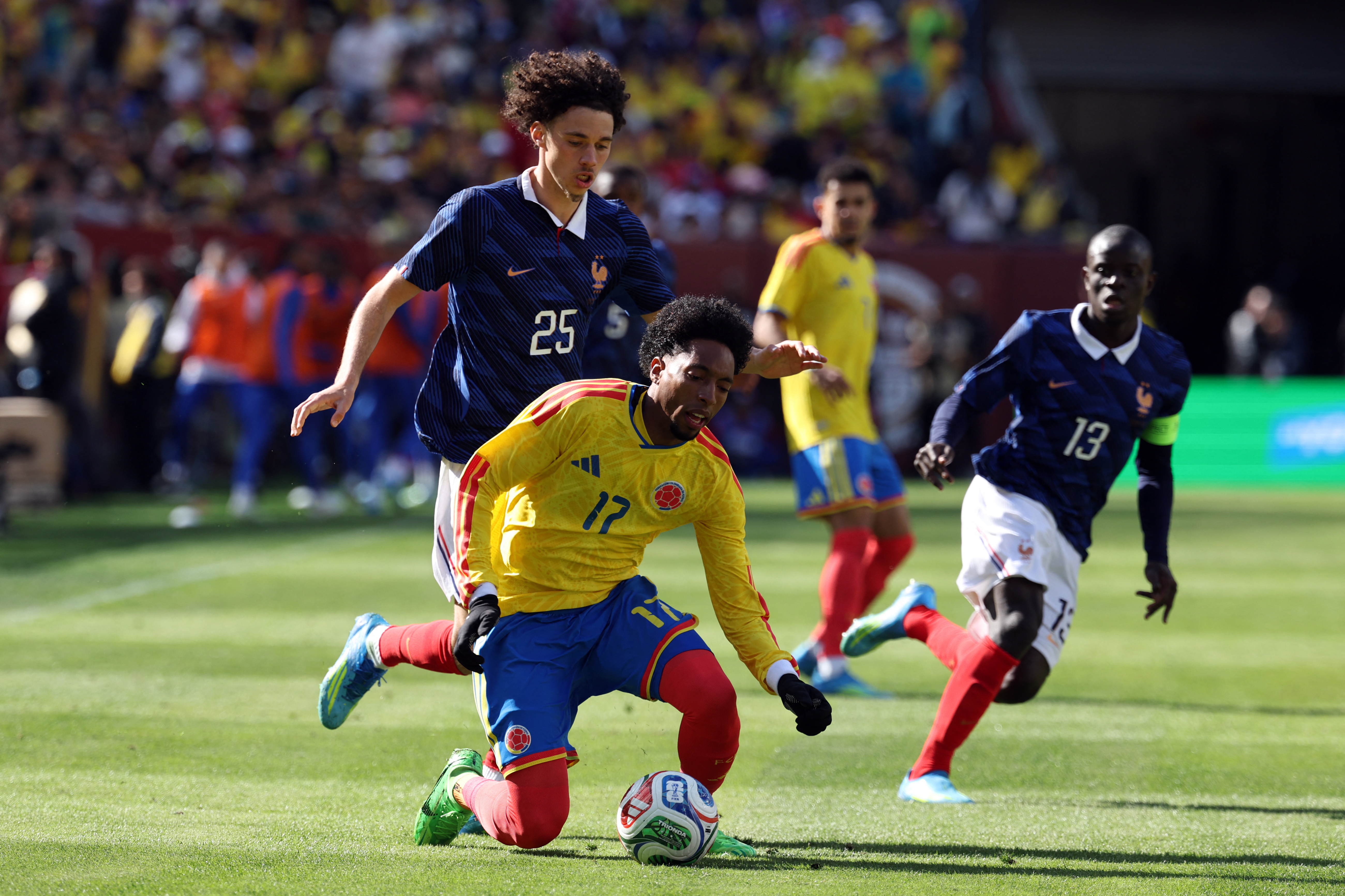 Colombia's defender #17 Johan Mojica is challenged by France's midfielder #25 Maghnes Akliouche during a friendly football match between Colombia and France at Northwest Stadium in Landover, Maryland, on March 29, 2026. (Photo by FRANCK FIFE / AFP)