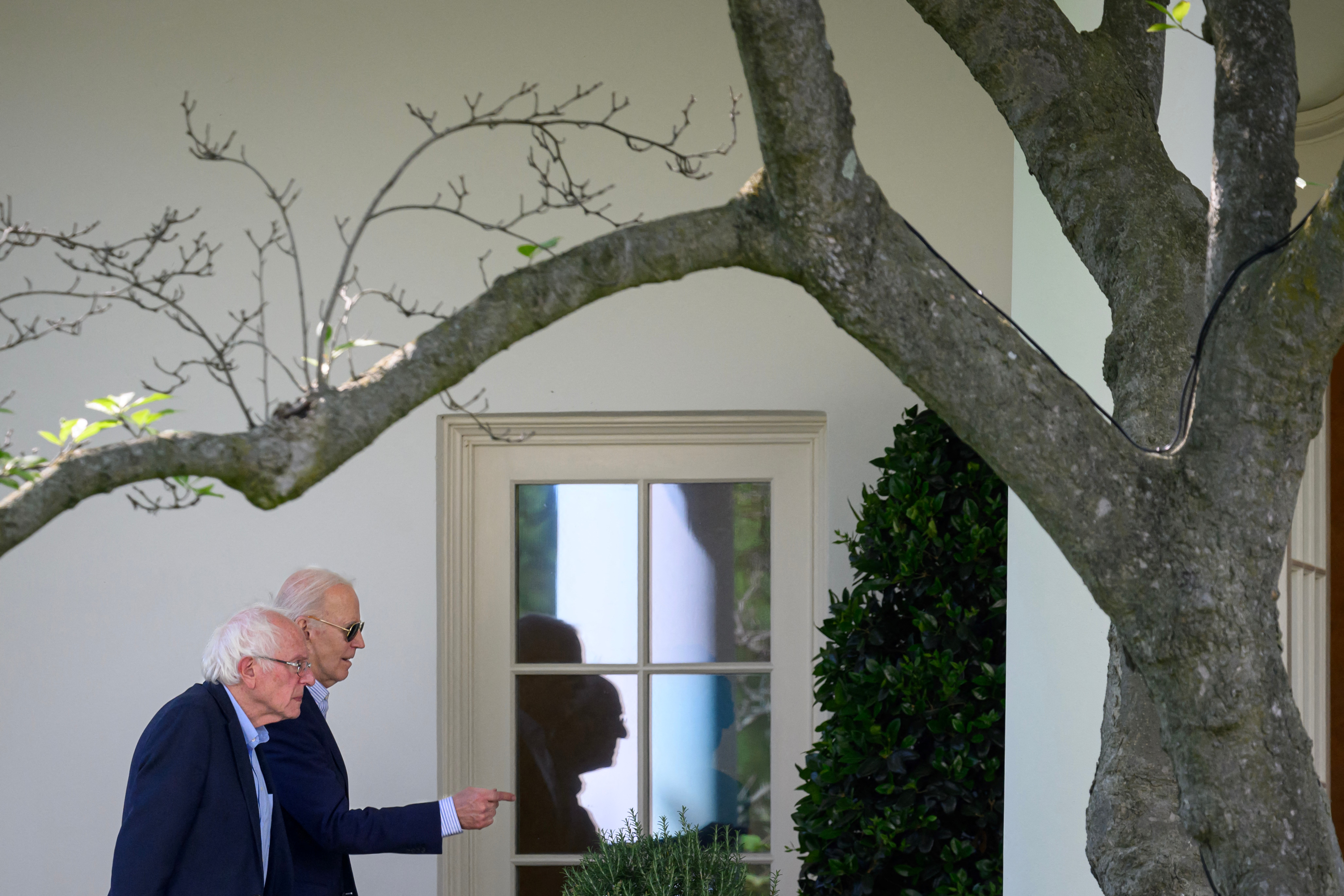(FILES) US President Joe Biden walks with US Senator Bernie Sanders, Independent of Vermont, towards the Oval Office upon arrival at the White House in Washington, DC, on April 22, 2024.
