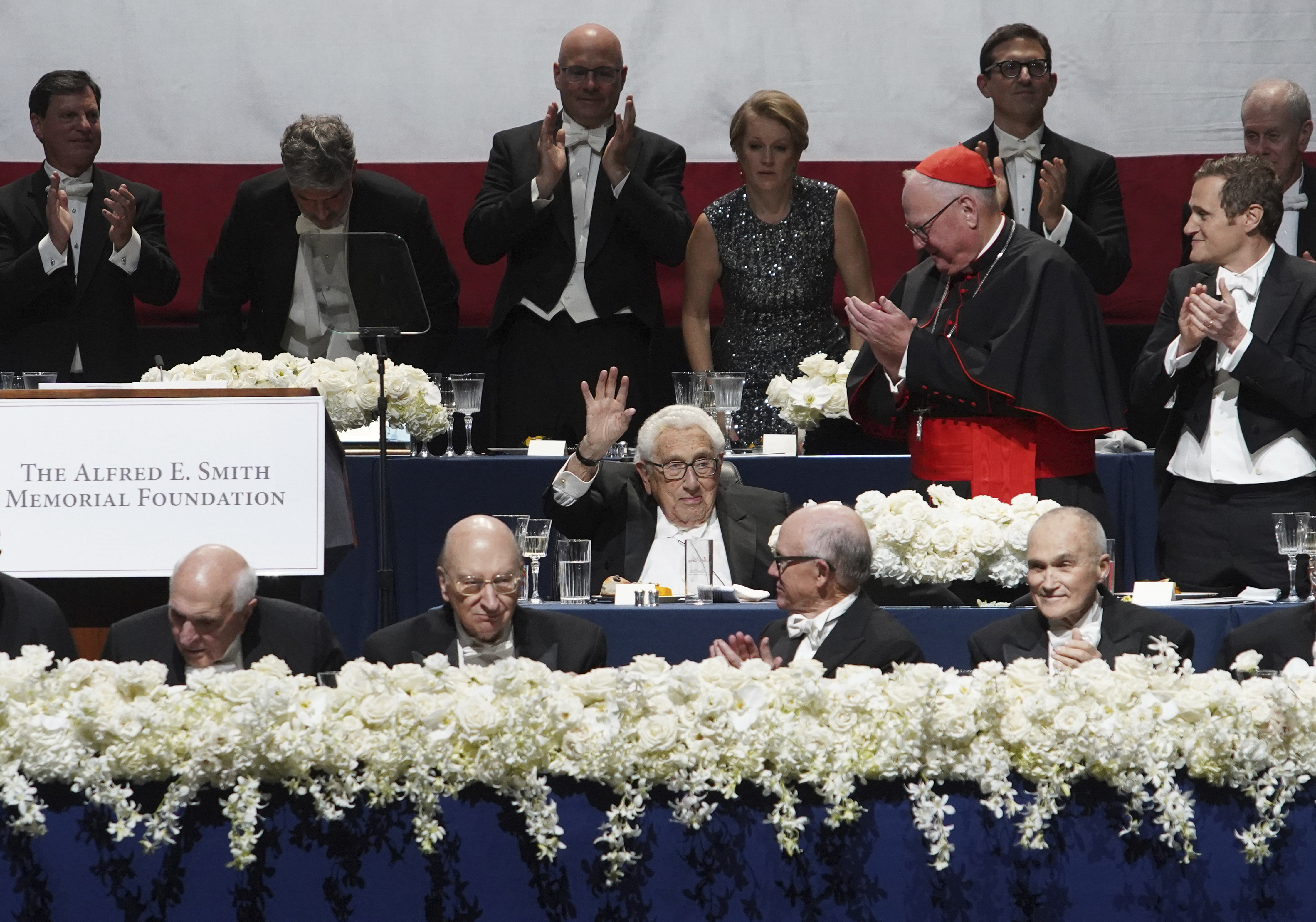 Keynote speaker and former United States Secretary of State Dr. Henry Kissinger, center, waves to guests at the 78th Annual Alfred E. Smith Memorial Foundation Dinner Thursday, Oct. 19, 2023, in New York. (AP Photo/Timothy Fadek)