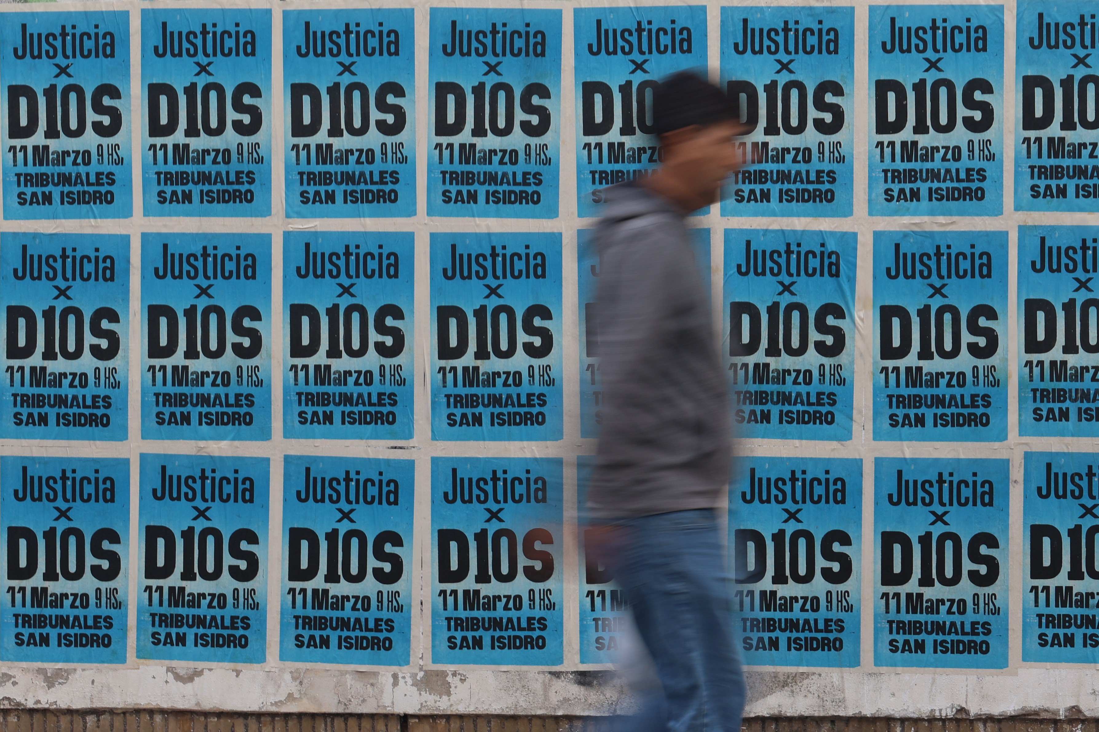 AME8477. BUENOS AIRES (ARGENTINA), 11/03/2025.- Una persona camina frente a los tribunales de San Isidro, donde se lleva a cabo el juicio por la muerte de Diego Armando Maradona, este martes, en Buenos Aires (Argentina). El mediático abogado Fernando Burlando, representante de Dalma y Giannina -hijas de Diego Armando Maradona- en el juicio por la muerte del astro argentino, aseguró que fue víctima de "un plan inhumano de resultado eficaz" y que "en cualquier hospital precario le hubieran salvado la vida". EFE/ Juan Ignacio Roncoroni