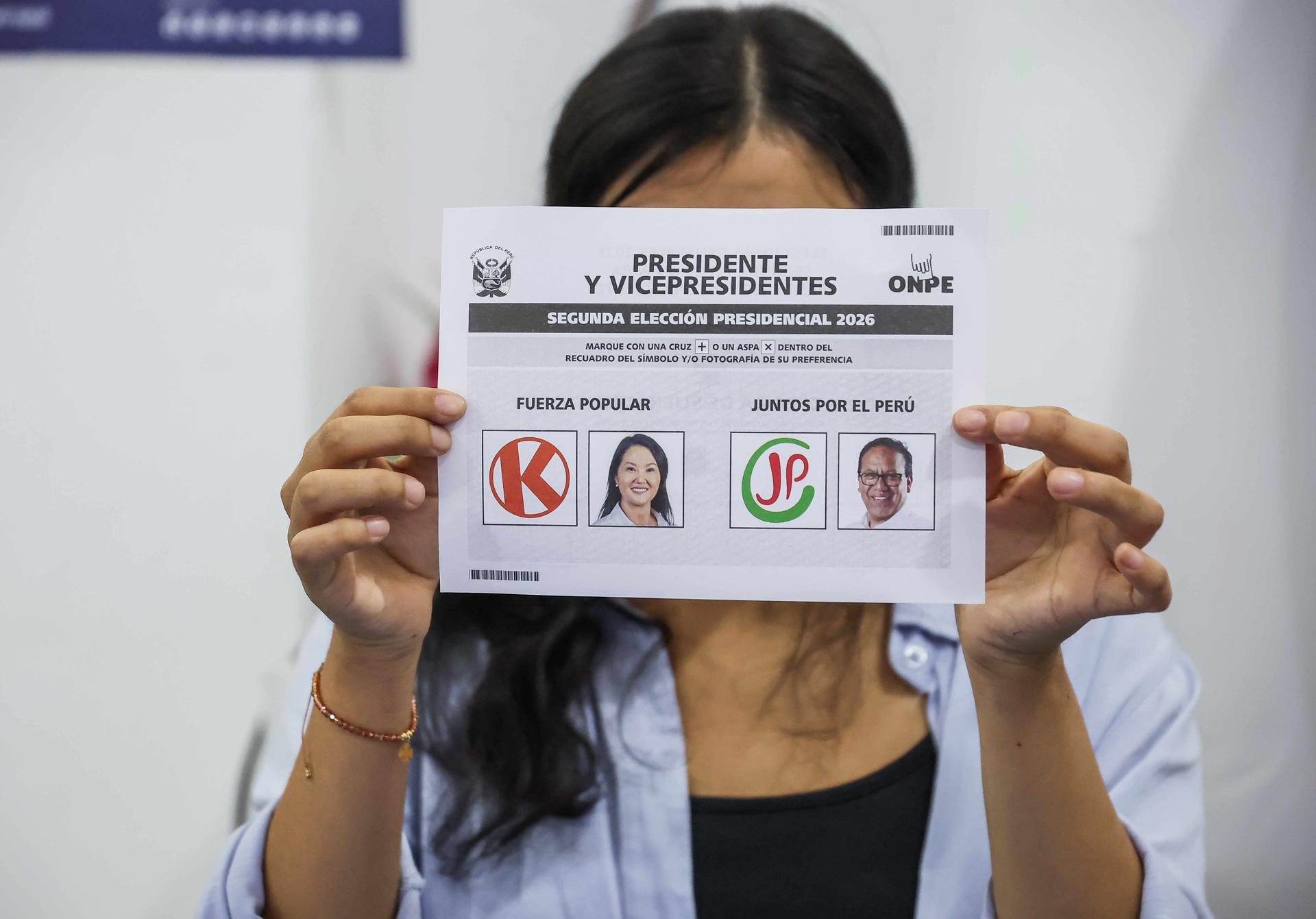 LIMA, 07/06/2026.- Una mujer muestra una papeleta electoral en un centro de votación en Lima, Perú, este domingo. La votación de la segunda vuelta de las elecciones presidenciales de Perú comenzó este domingo en el país andino para elegir entre la candidata derechista Keiko Fujimori y el candidato izquierdista Roberto Sánchez al noveno presidente del país en diez años. EFE/ Paul Vallejos