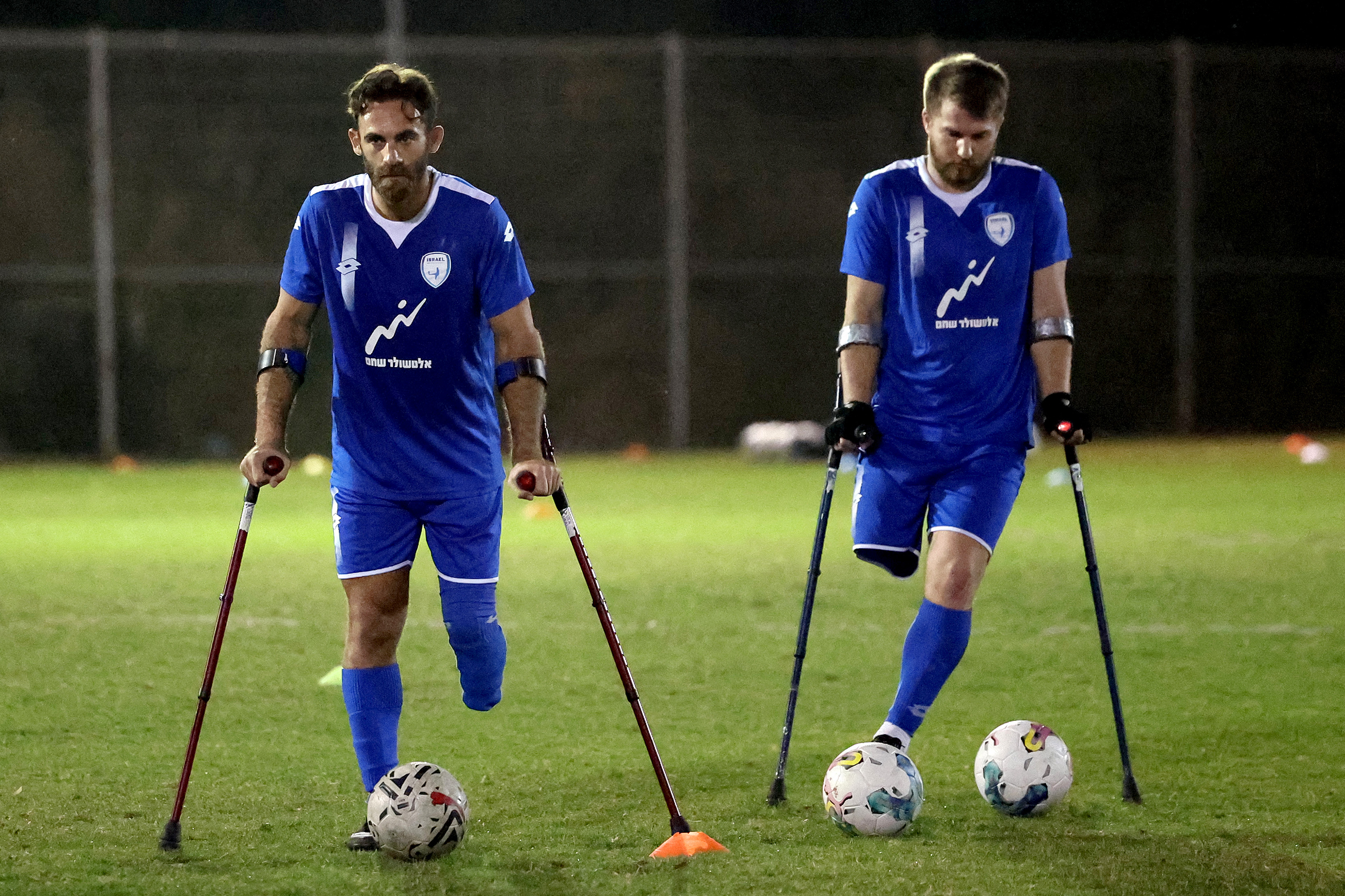 Zach Shichrur y Ben Binyamin asisten a una sesión de entrenamiento para el equipo de fútbol de amputados de Israel en la ciudad israelí de Ramat Gan, cerca de Tel Aviv, el 28 de marzo de 2024. (Foto de JACK GUEZ / AFP)