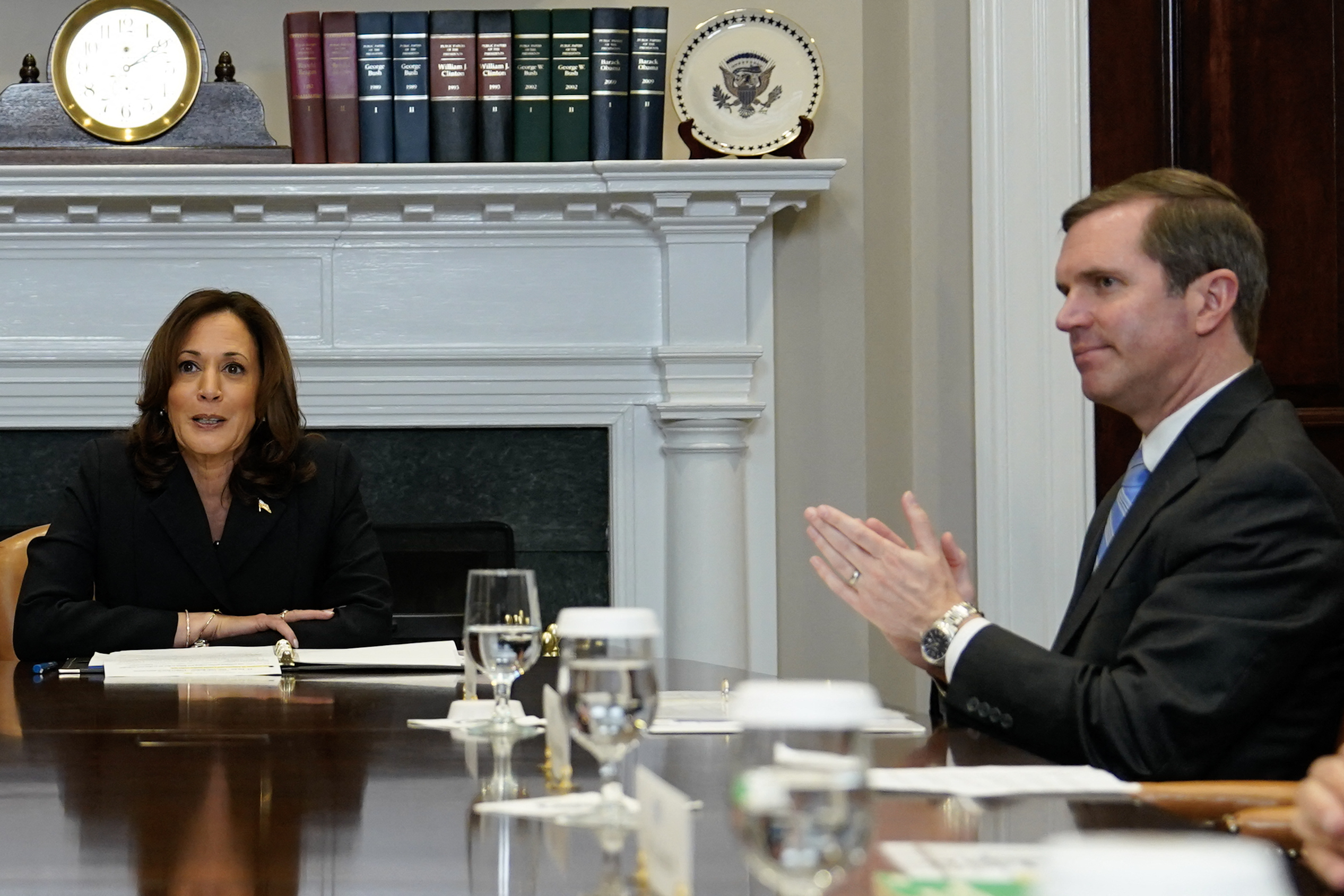 (FILES) Kentucky Governor Andy Beshear (R) looks on as US Vice President Kamala Harris speaks during a roundtable conversation about marijuana reform and criminal justice reform, in the Roosevelt Room of the White House on March 15, 2024 in Washington, DC.