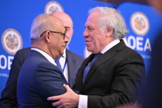 (L-R) OAS Secretary General-elect Albert Ramdin embraces outgoing OAS Secretary General Luis Almagro during an Organization of American States (OAS) special General Assembly to elect new Secretary General, at OAS headquarters in Washington, DC, on March 10, 2025.