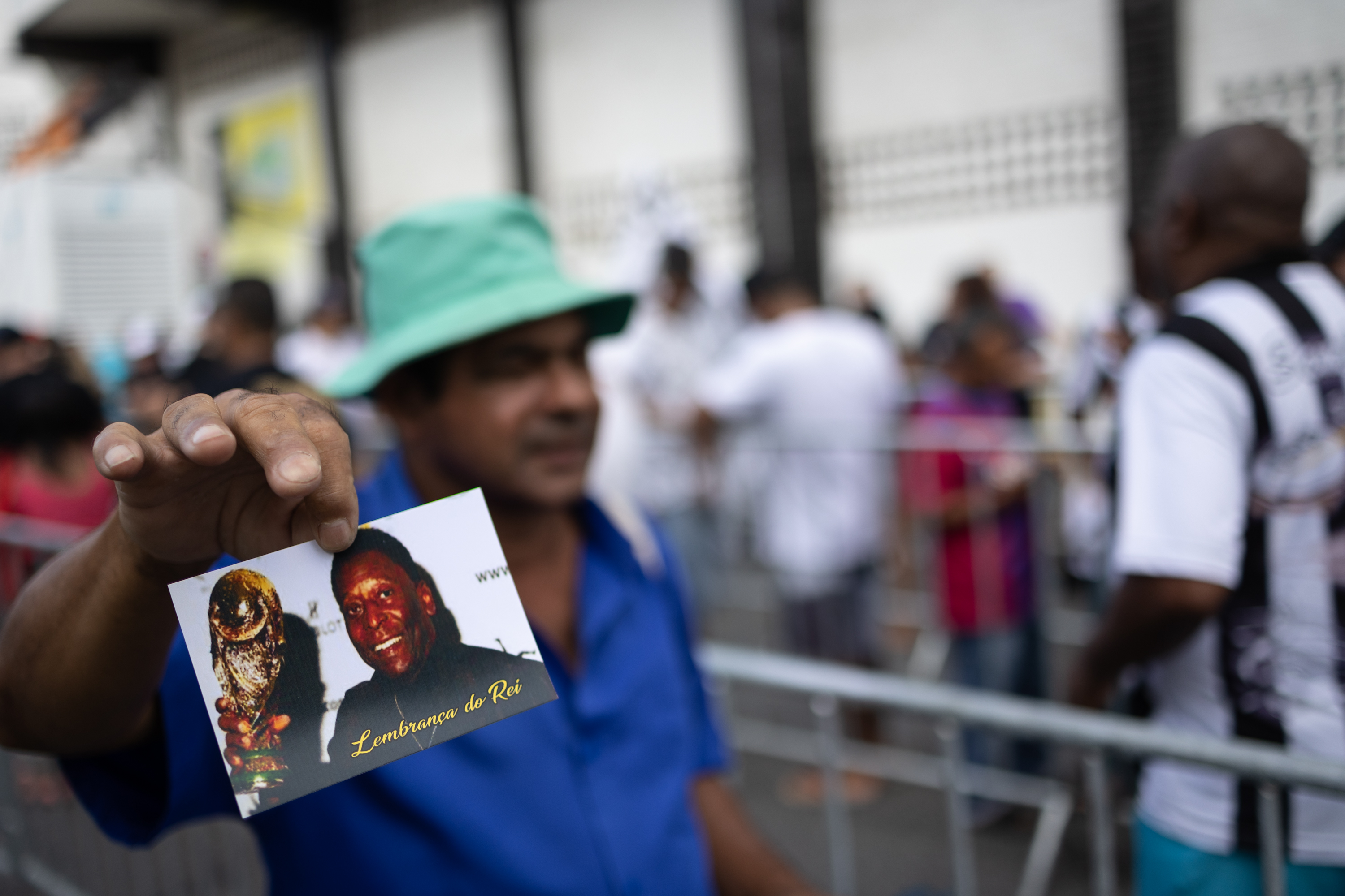 AME3840. SANTOS (BRASIL), 02/01/2023.- Un comerciante vende souvenirs de Pelé durante el velatorio de Edson Arantes do Nascimento 'Pelé' hoy, en el estadio Vila Belmiro de la ciudad de Santos (Brasil). Varios aficionados al fútbol brasileños pasaron la noche guardando fila para acudir este lunes al velatorio de Pelé, fallecido el pasado jueves a los 82 años. EFE/ Isaac Fontana