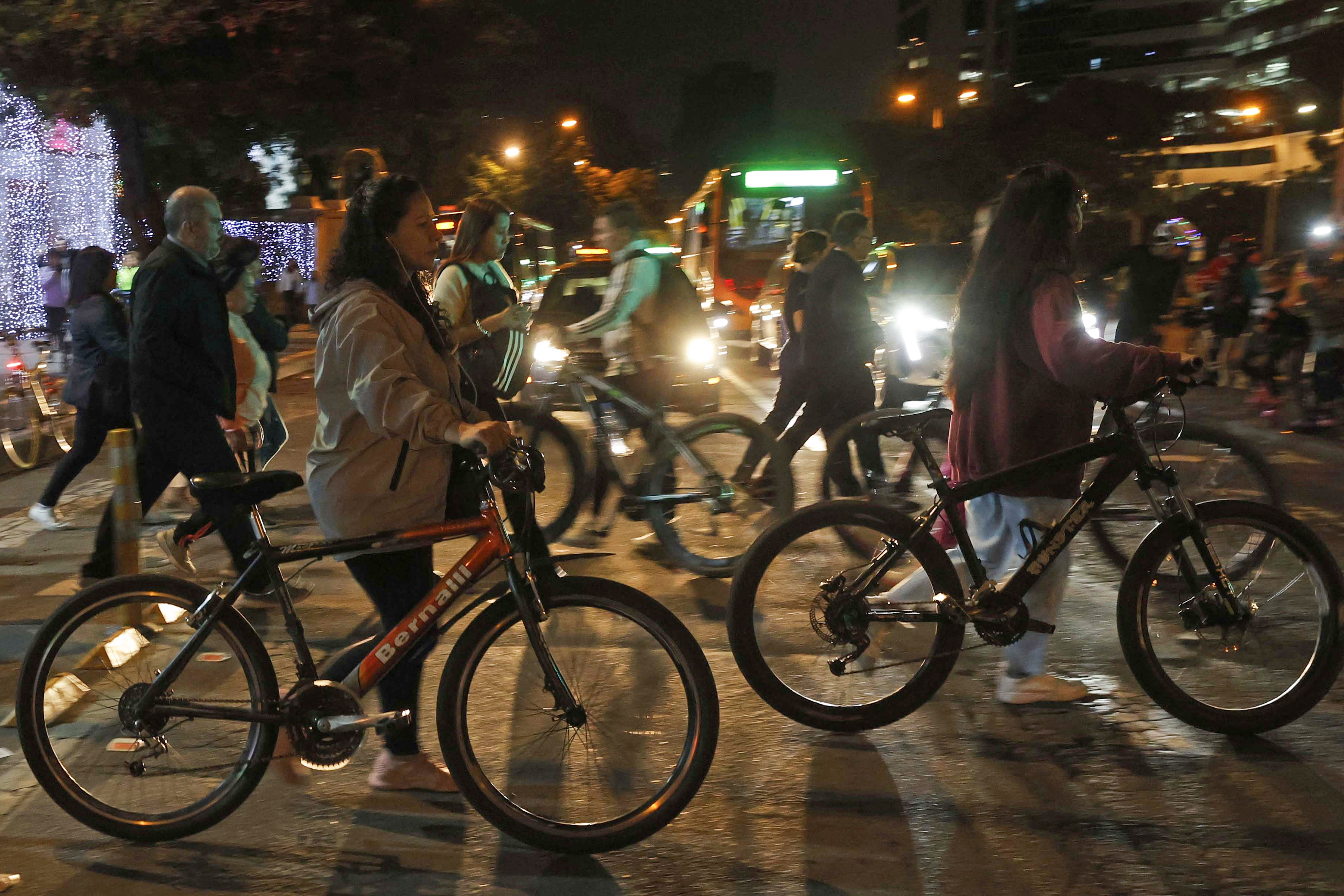 AME5144. BOGOTÁ (COLOMBIA), 13/12/2024.- Personas se movilizan en bicicleta este jueves, durante una jornada de ciclovía nocturna en Bogotá (Colombia). EFE/ Mauricio Dueñas Castañeda