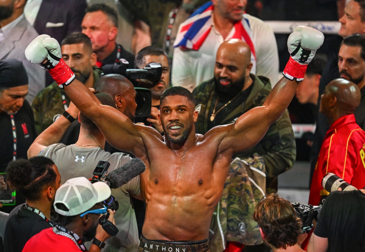 (FILES) British boxer Anthony Joshua celebrates after defeating US boxer and influencer Jake Paul (off frame) in a non-title heavyweight bout at the Kaseya Center in Miami, Florida, on December 19, 2025.