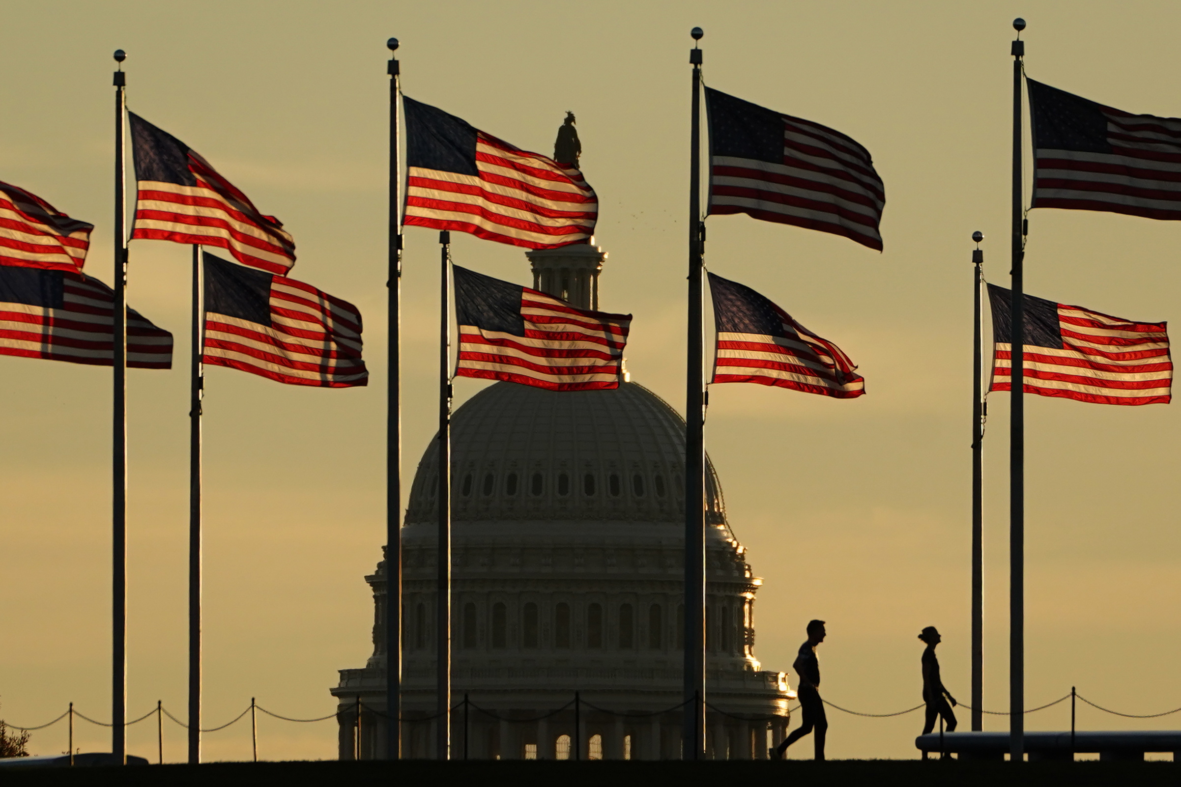 Washington Dc (United States), 08/11/2022.- Joggers pass US flags on the National Mall in front of the Capitol Building in Washington, DC, USA, 08 October 2022. The US midterm elections are held every four years at the midpoint of each presidential term and this year include elections for all 435 seats in the House of Representatives, 35 of the 100 seats in the Senate and 36 of the 50 state governors as well as numerous other local seats and ballot issues. (Elecciones, Estados Unidos) EFE/EPA/WILL OLIVER