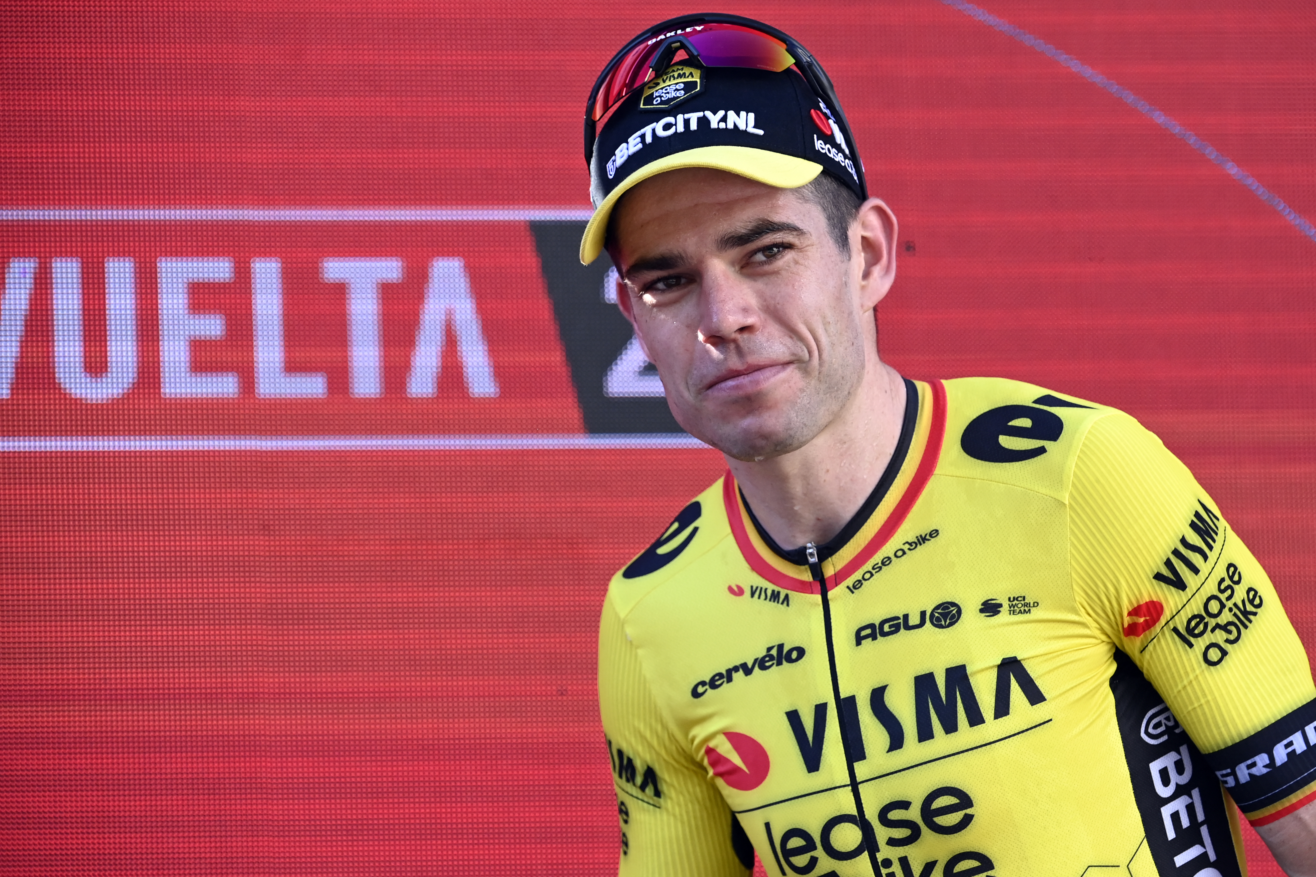 Overall ranking leader Team Visma's Wout van Aert walks up to the podium after winning the stage 3 of La Vuelta a Espana cycling tour, a 191.2 km race between Lousa and Castelo Branco, on August 19, 2024. (Photo by MIGUEL RIOPA / AFP)