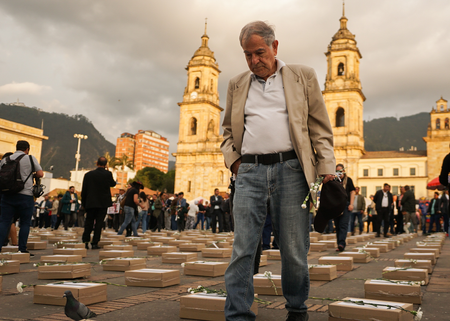 Luis Fernando Herrera, asistente a la movilización contra la violencia hacia líderes y ex-FARC, trata de ubicar el nombre de un exguerrillero asesinado como parte de un acto simbólico.