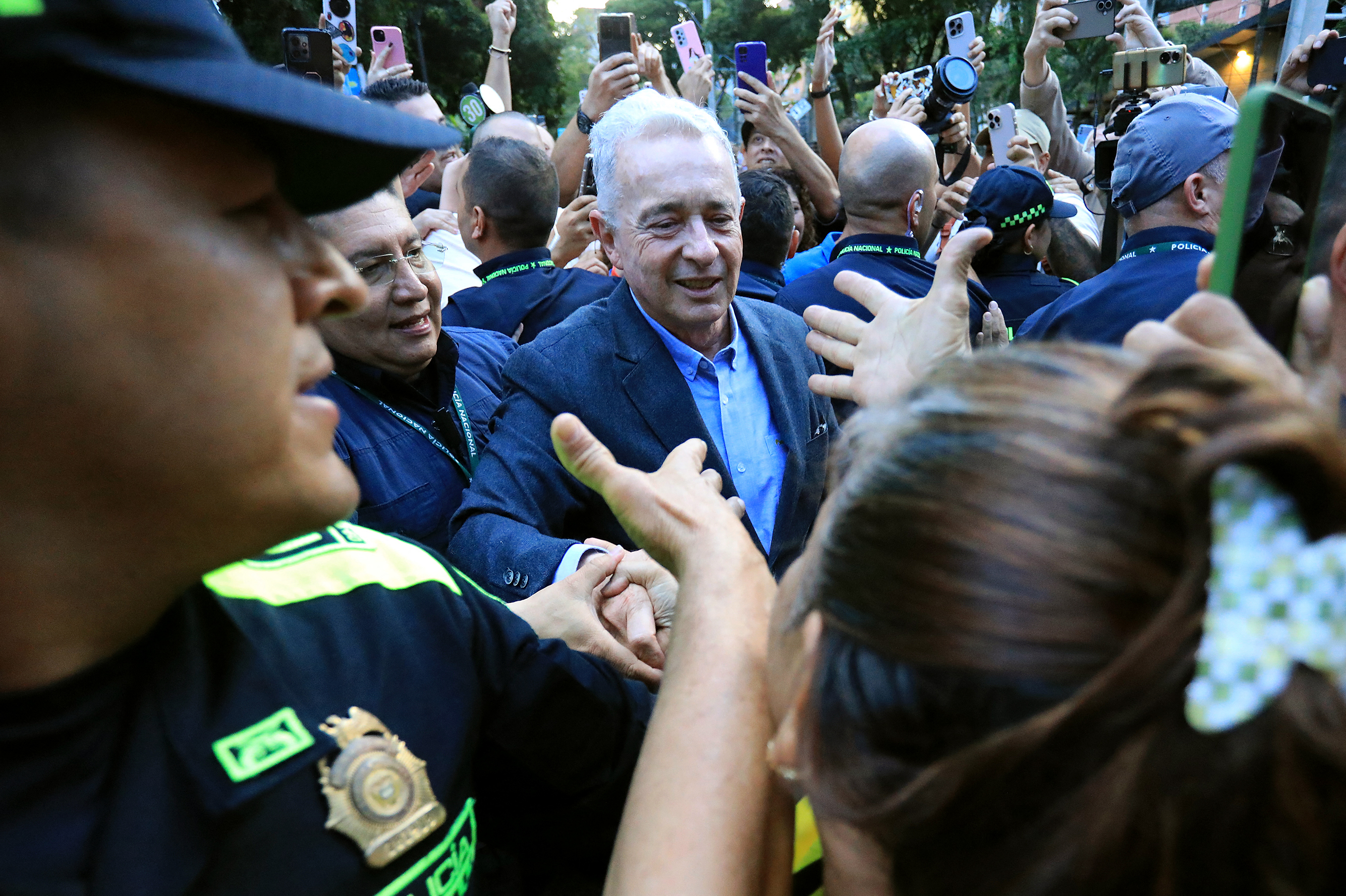 (FILES) Former Colombian President Alvaro Uribe Velez (C) greets a supporter after being released from house arrest in Sabaneta, Antioquia department, Colombia on August 20, 2025.