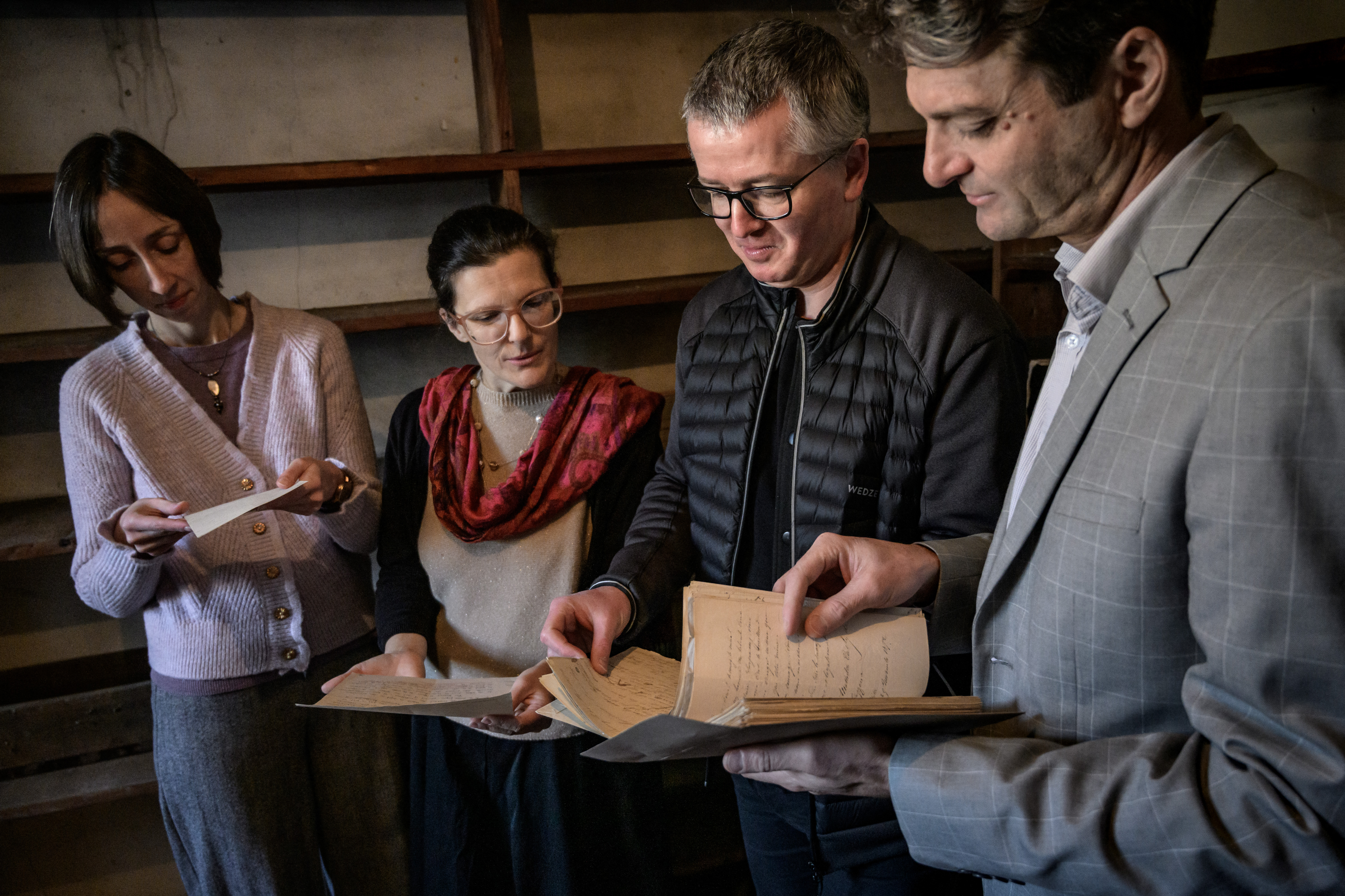 Pierre-Emmanuel Guilleray, Curator of Ancient Collections at the Besançon Archives Library (R) and the team of curators who found the letters written by French painter Gustave Courbet to his beloved Mathilde, handle the letters at the very spot where they were found in Besançon on November 27, 2024.
