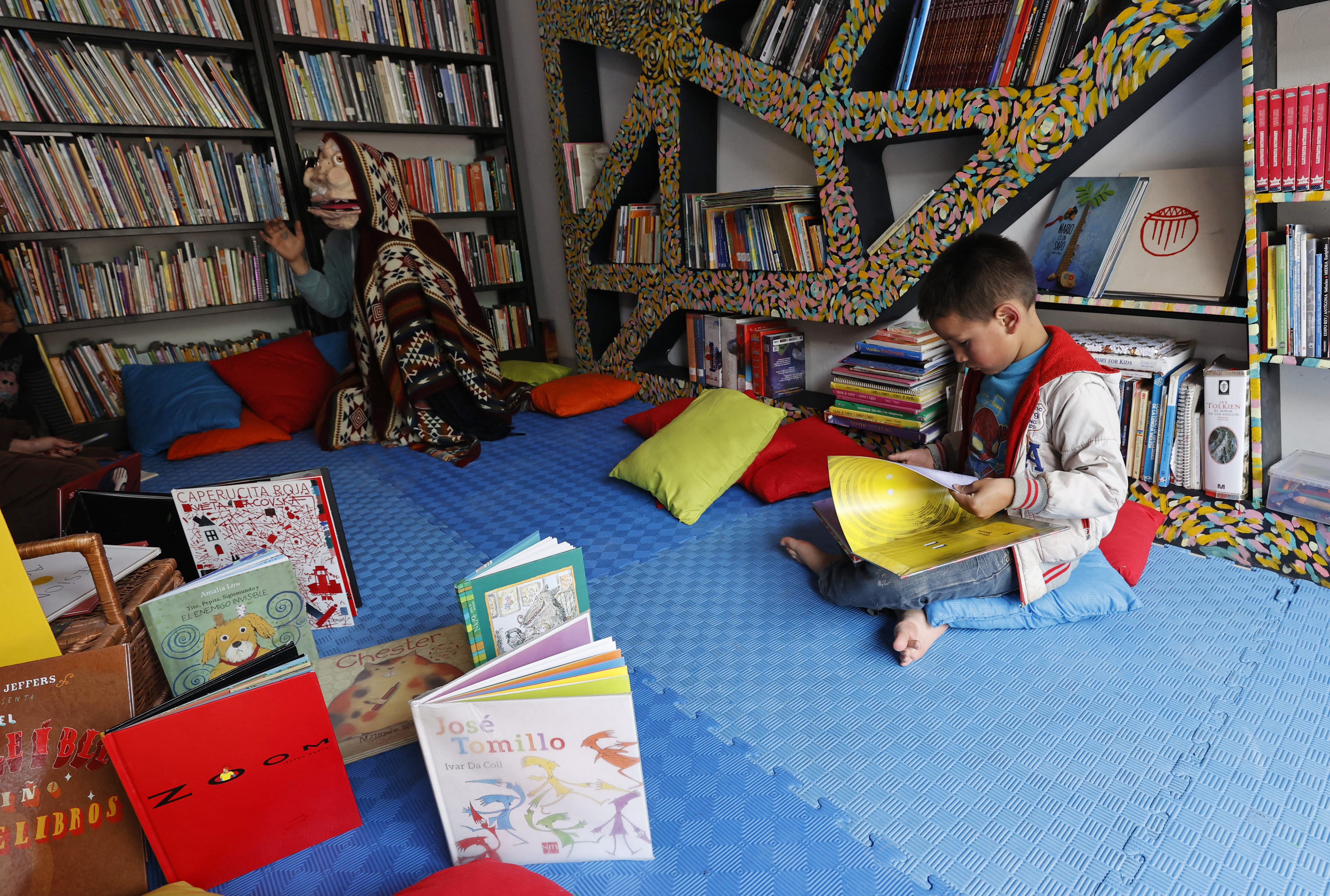 ACOMPAÑA CRÓNICA: COLOMBIA CONFLICTO BOG300. BOGOTÁ (COLOMBIA), 05/11/2022.- Un niño lee en la Biblioteca Comunitaria Violetta el 4 de noviembre de 2022 en la localidad de Ciudad Bolívar en Bogotá (Colombia). A unos quince kilómetros del centro de Bogotá está Ciudad Bolívar, una populosa localidad en donde las palabras "memoria" y "violencia" recorren sus calles en forma de coloridos murales y se repiten como un mantra entre sus habitantes que no contemplan el olvido como opción para su historia. EFE/ Mauricio Dueñas Castañeda