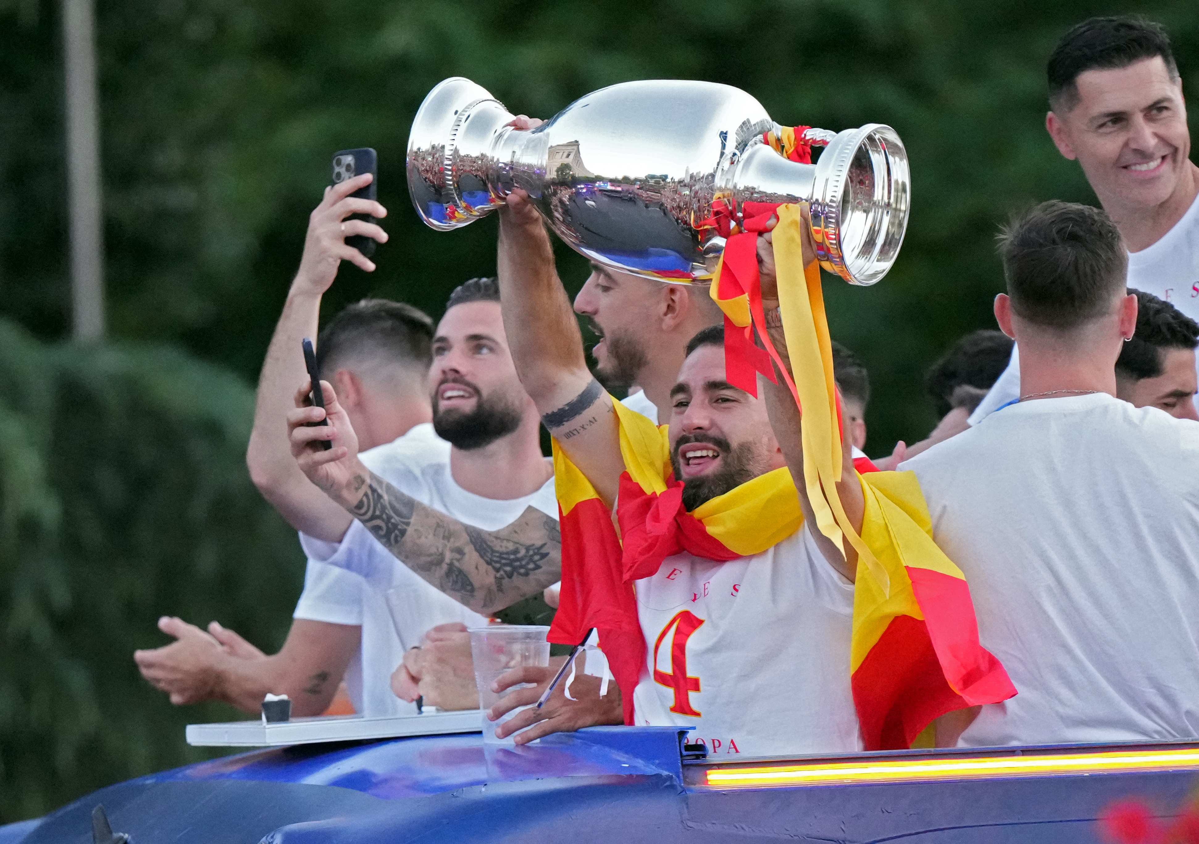 Spanish national football team players parade on board of a bus as Spain fans gather to celebrate, on July 15, 2024, after Spain won the UEFA Euro 2024 final football match between Spain and England.  (Photo by CESAR MANSO / AFP)
