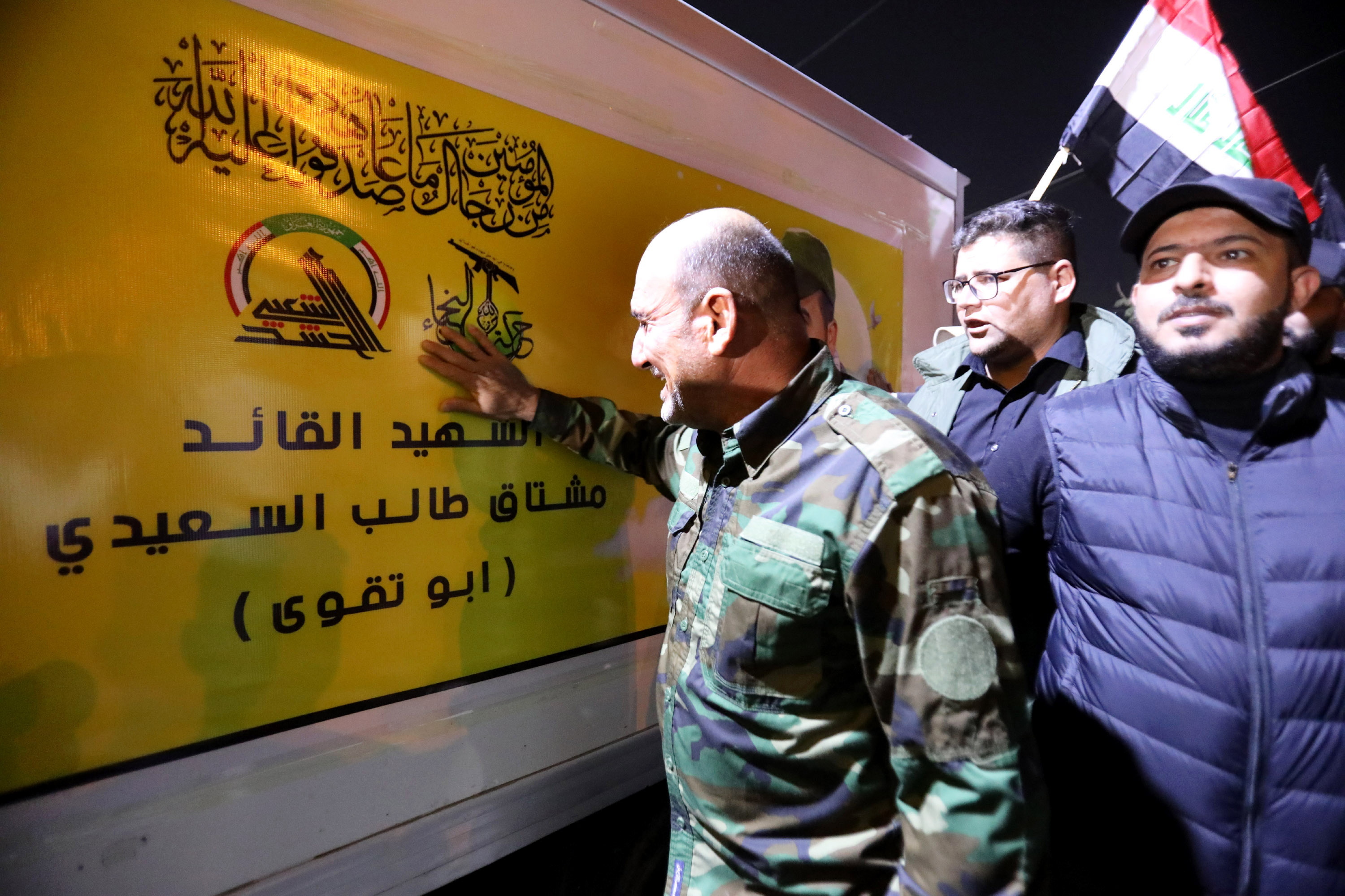 Baghdad (Iraq), 04/01/2024.- Members of Iraqi Shiite Popular Mobilization Forces (PMF) mourn next to a truck carrying the coffin of their leader Abu Taqwa Al-sia'di, who was killed in a US drone attack in Baghdad, during a funeral procession in Baghdad, Iraq, 04 January 2024. A US drone strike on January 4, targeted an Iranian-backed Popular Mobilization Forces base in eastern Baghdad, killing two commanders and wounding six others from the Popular Mobilization Forces' 12th Brigade, PMF announced to the media. (Bagdad) EFE/EPA/AHMED JALIL
