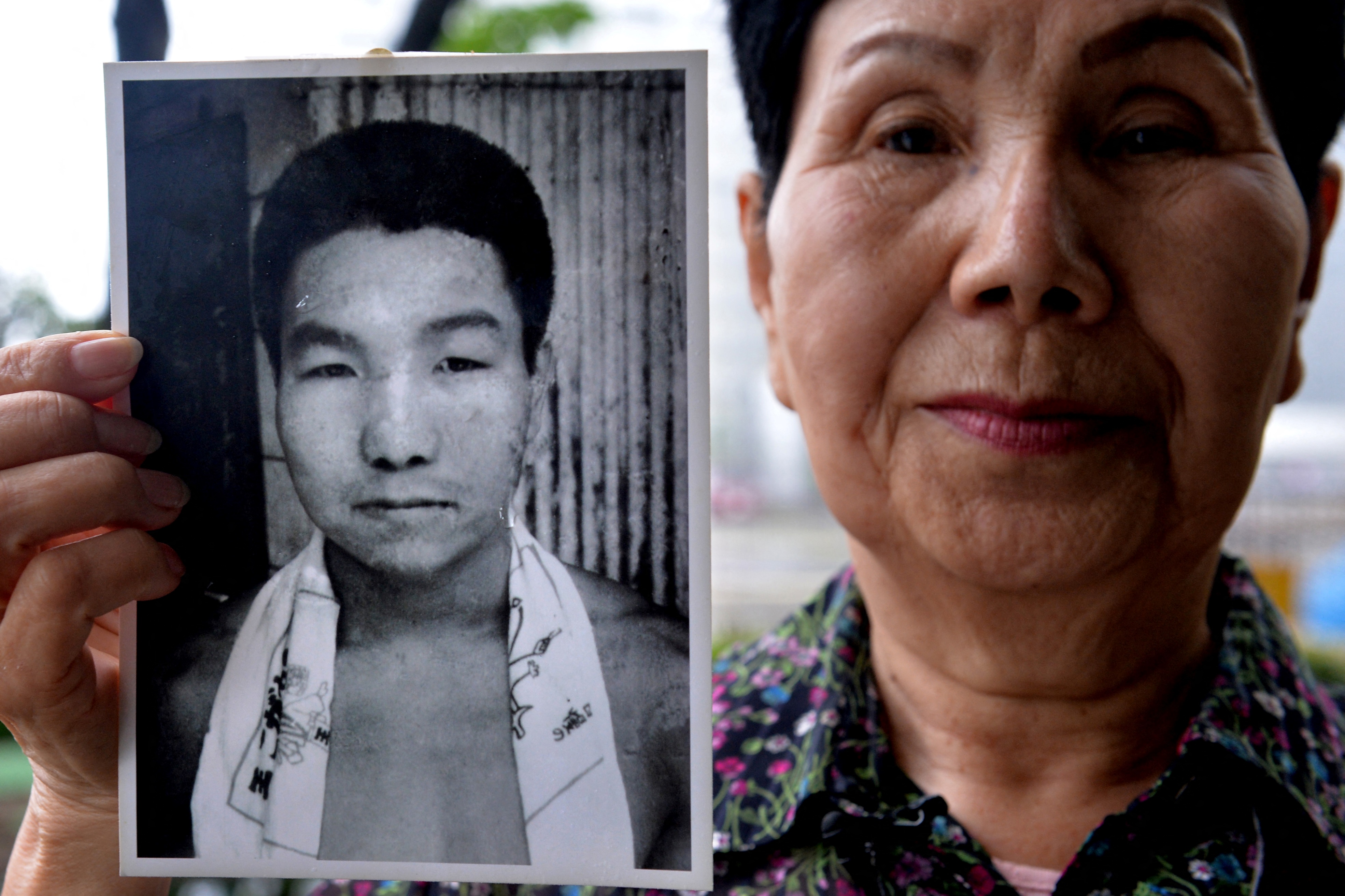 (FILES) This file photo taken on May 20, 2013 shows Hideko Hakamada, sister of former boxer Iwao Hakamada who had been on death row in Japan for 47 years, showing a picture of her young brother Iwao, during an interview outside the Tokyo Detention House in Tokyo.