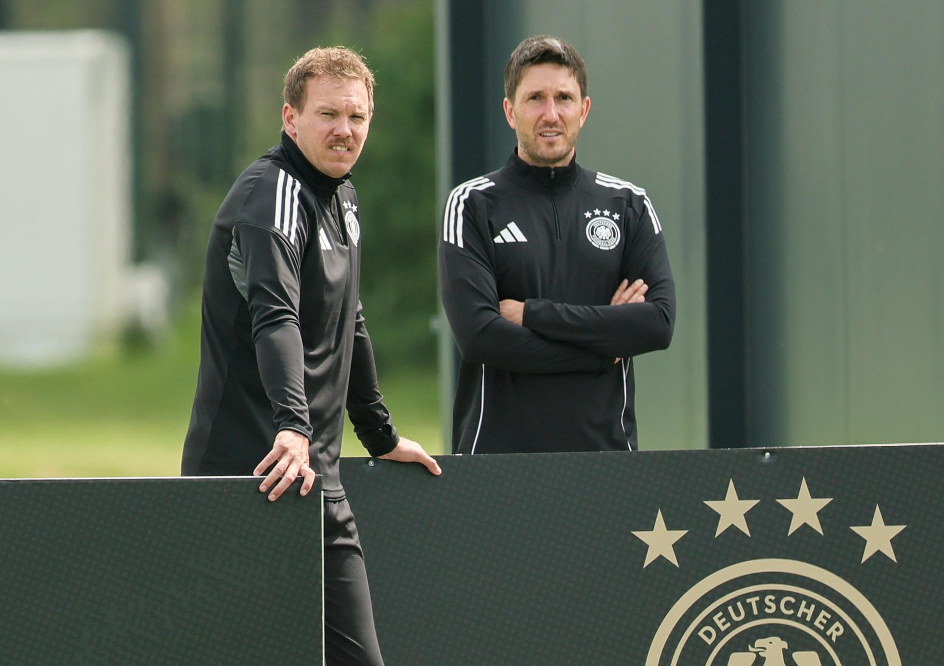 Herzogenaurach (Germany), 03/06/2025.- Germany national soccer team head coach Julian Nagelsmann (L) and assistant coach Benjamin Glueck look on during a training session in Herzogenaurach, Germany, 03 June 2025. Germany will face Portugal in their UEFA Nations League semi-final match on 04 June in Munich. (Alemania) EFE/EPA/RONALD WITTEK
