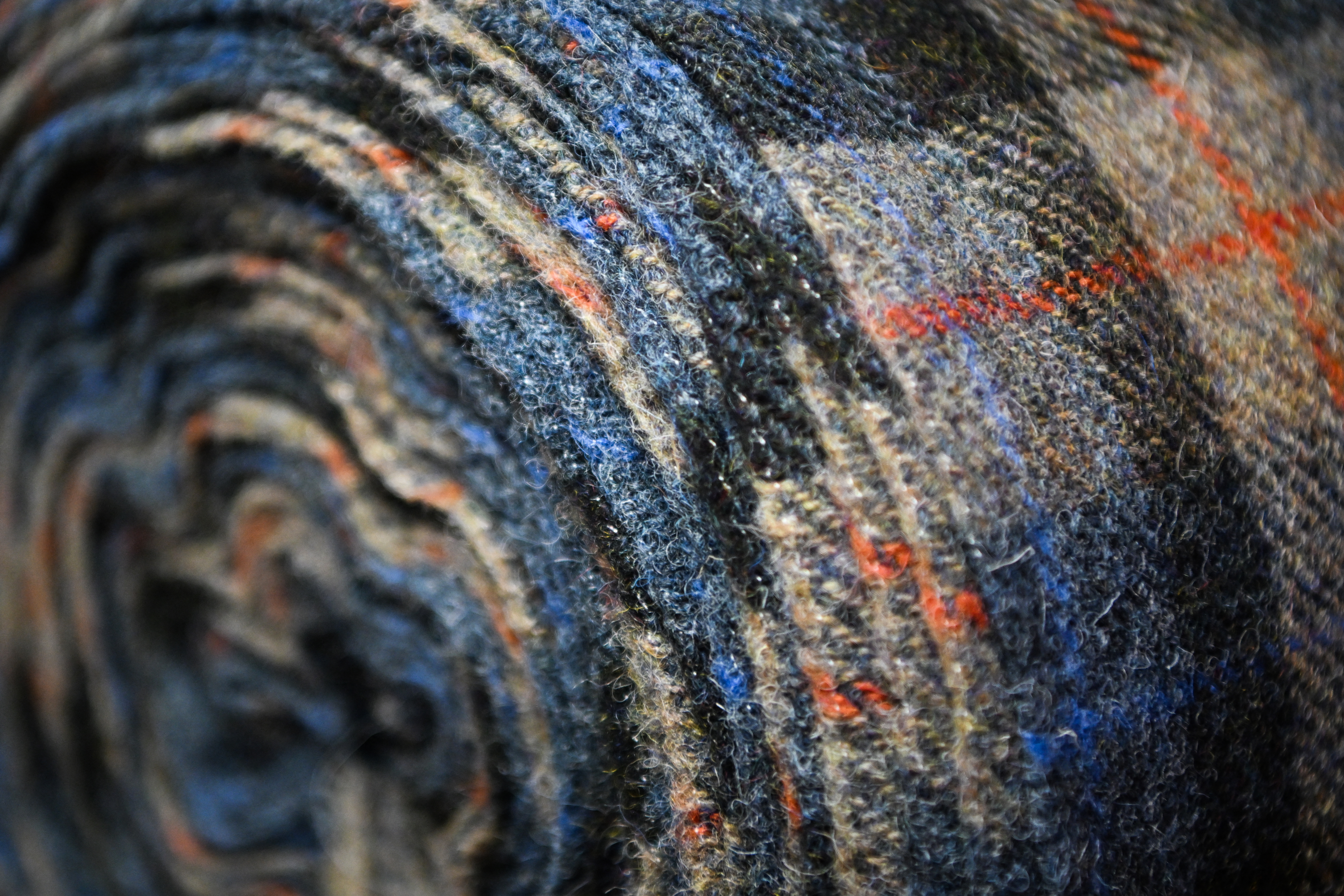 A photograph taken on April 28, 2025 shows Harris Tweed stoles displayed at the Isle of Harris Tweed shop, in Tarbert, Isle of Harris, in the Outer Hebrides, northern Soctland.