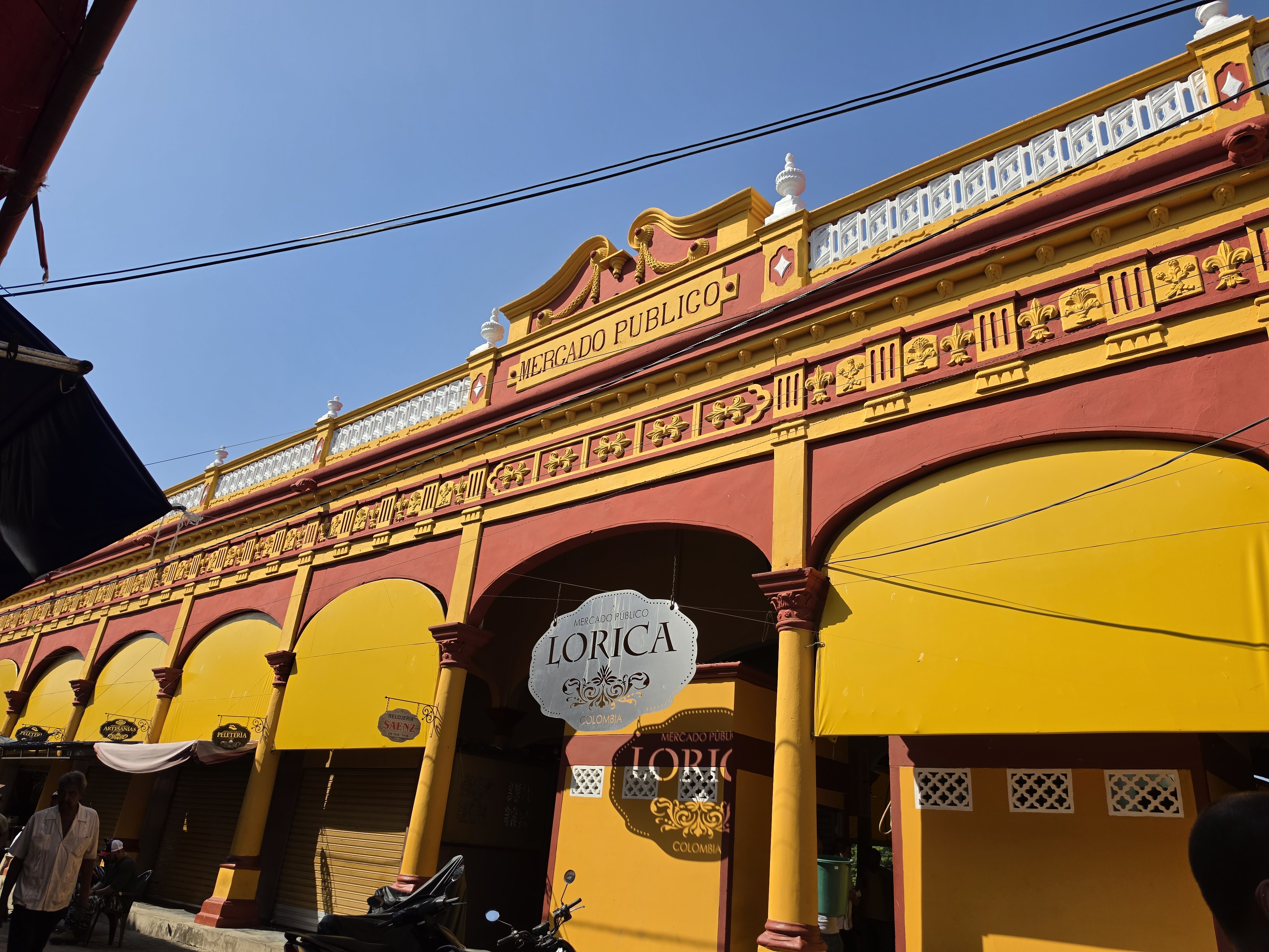 A menos de una hora de Montería aparece nuestro segundo destino: Santa Cruz de Lorica. Este es uno de los pueblos patrimoniales más fascinantes de Colombia, y es que su arquitectura republicana, enriquecida por la influencia sirio-libanesa, se refleja en edificios emblemáticos como el Mercado Público, el Edificio Afife Matuk, el Club Lorica y la Catedral de Santa Cruz, que narran la historia de una ciudad que floreció gracias al comercio sobre el río Sinú.
