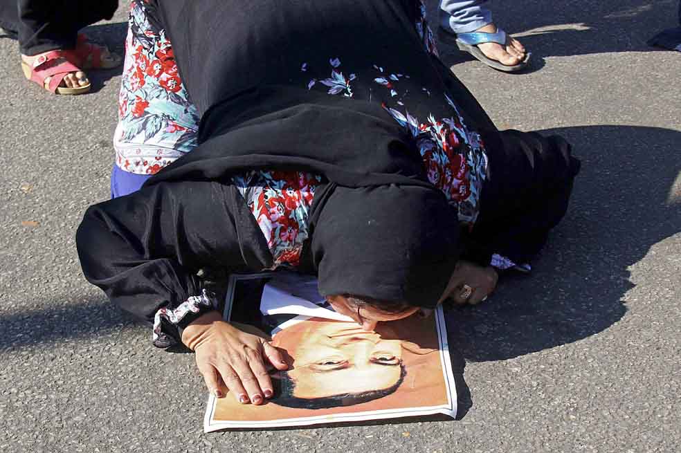 29 de Noviembre, 2014. Una mujer besa la imagen del expresidente egipcio Hosni Mubarak, después de conocida la decisión de la Corte Criminal de El Cairo, que levantó los cargos contra el exmandatario por supuestos crímenes ocurridos durante las protestas sociales de 2012. /EFE y AFP