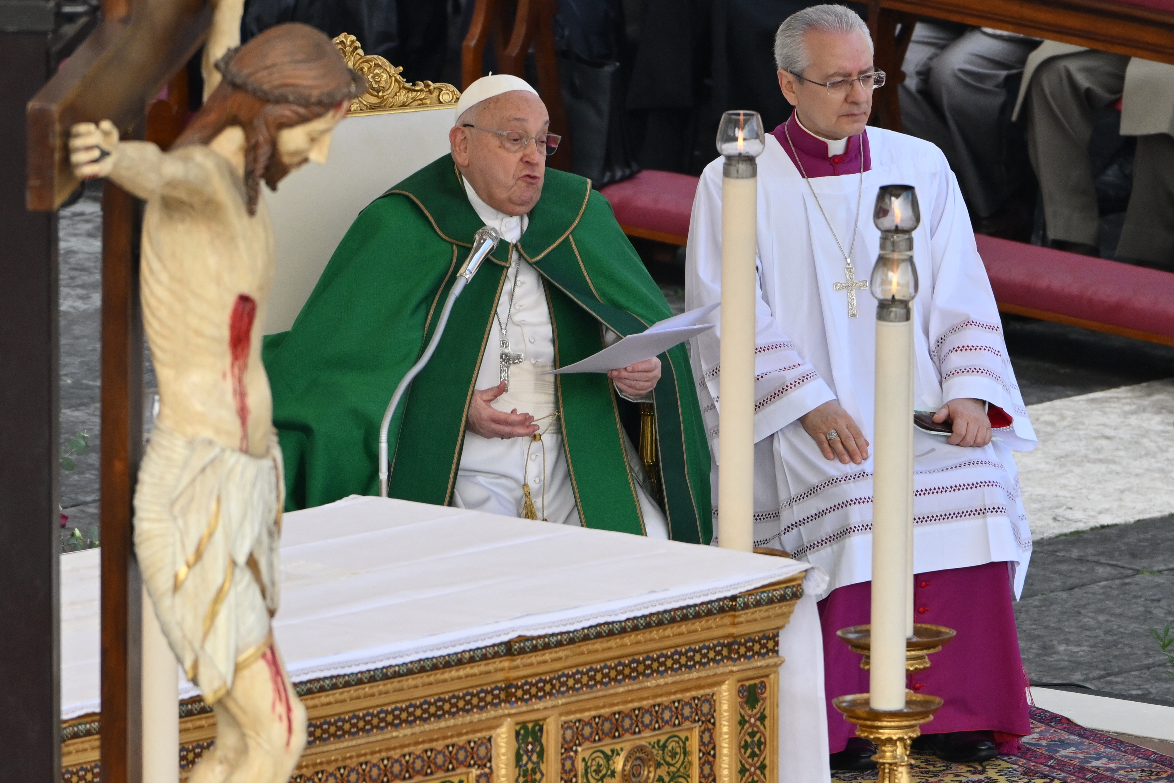 Pope Francis (L) celebrates the mass for the Jubilee of the Armed Forces at St. Peter's square in the Vatican on February 9, 2025. (Photo by Alberto PIZZOLI / AFP)