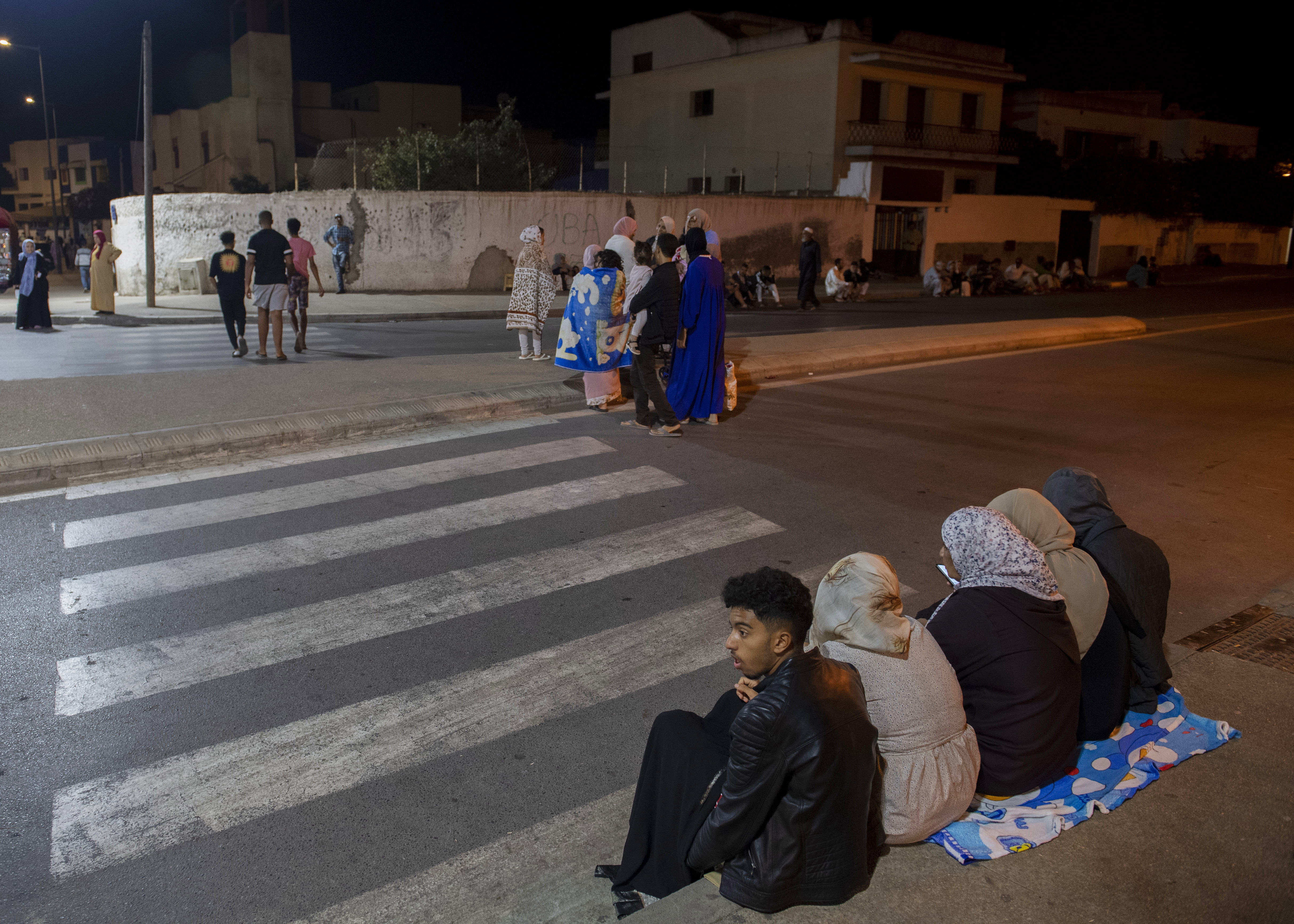 Rabat (Morocco), 08/09/2023.- People seek safety outside after an earthquake in Rabat, Morocco, 08 September 2023. A 6.8-magnitude earthquake struck Morocco late 08 September, damaging buildings in major cities and sending panicked people pouring into streets and alleys. According to Morocco's state-run media, at least 296 people died in the earthquake in the provinces and prefectures of Al Haouz, Marrakech, Ouarzazate, Azilal, Chichaoua and Taroudant, and 153 people were injured. (Terremoto/sismo, Marruecos) EFE/EPA/Jalal Morchidi