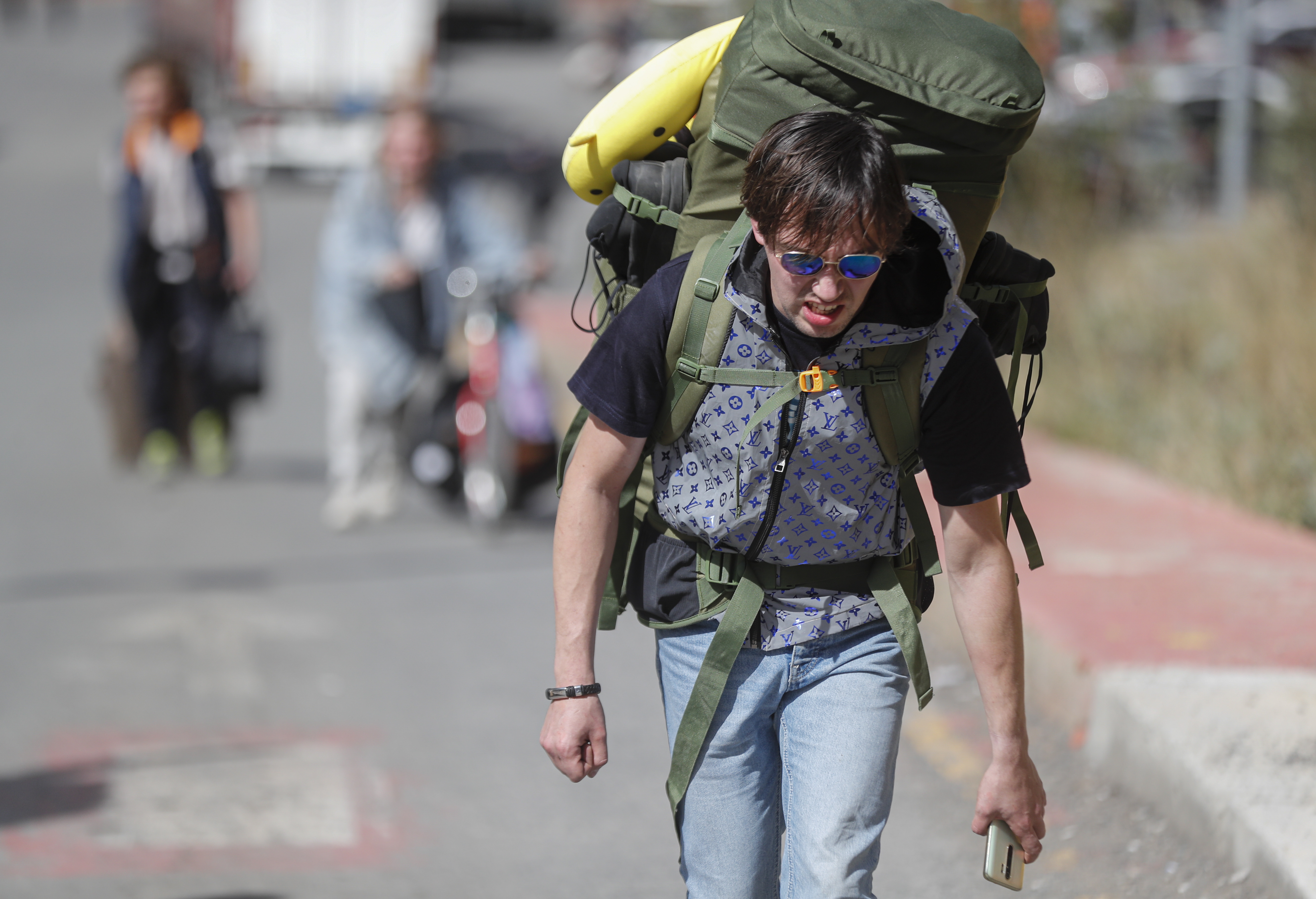 Verkhnii Lars (Georgia), 27/09/2022.- A Russian man with a backpack walks along a road after passing through customs at the Georgia-Russia border checkpoint of Verkhnii Lars, Georgia, 27 September 2022. Thousands of Russian men left Russia after Russian President Putin announced in a televised address to the nation on 21 September, that he signed a decree on partial mobilization in the Russian Federation due to the conflict in Ukraine. Russian Defense Minister Shoigu said that 300,000 people would be called up for service as part of the move. Georgian Interior Minister Vakhtang Gomelauri said on 27 September, that in recent days some 10,000 Russians have crossed the border with Georgia every day. On 24 February 2022 Russian troops entered the Ukrainian territory in what the Russian president declared a 'Special Military Operation', starting an armed conflict that has provoked destruction and a humanitarian crisis. (Rusia, Ucrania, Estados Unidos) EFE/EPA/ZURAB KURTSIKIDZE