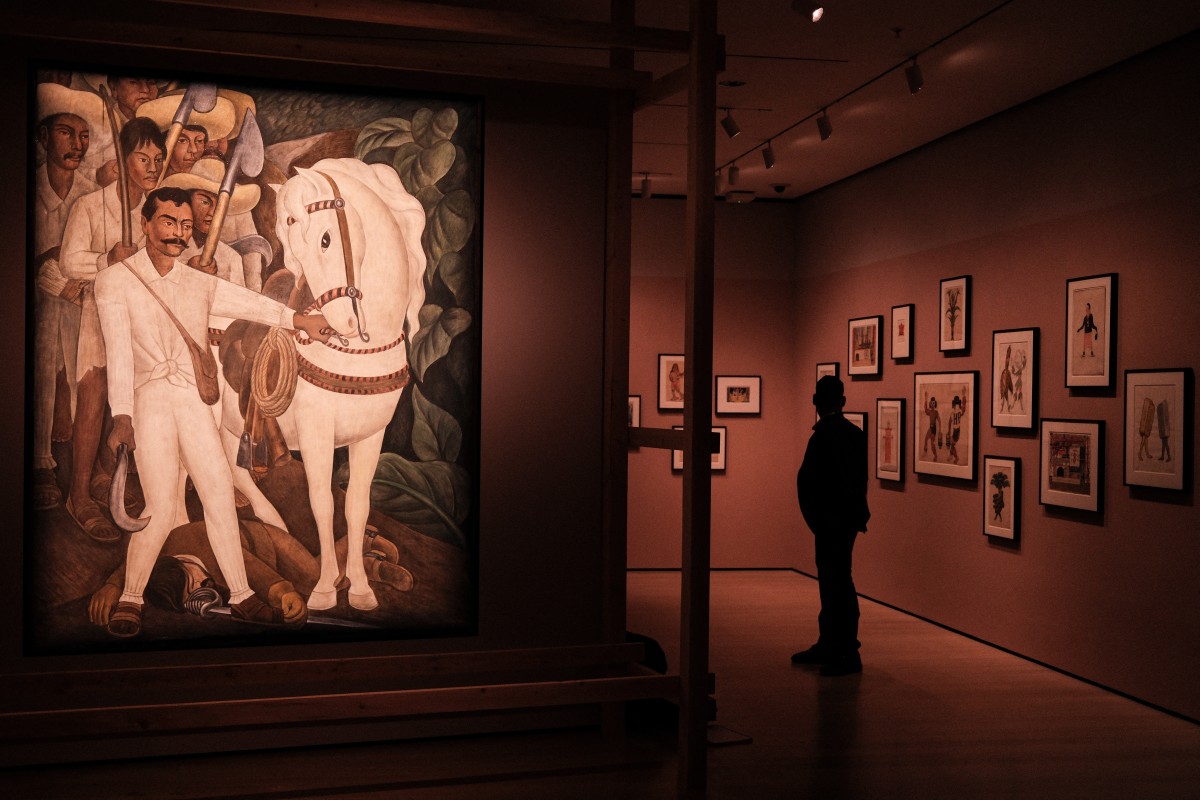 The painting "Agrarian Leader Zapata" by Diego Rivera is displayed as a man views artworks during a press preview of the exhibition "Frida and Diego: The Last Dream" at the Museum of Modern Art (MoMA) in New York City on March 16, 2026.